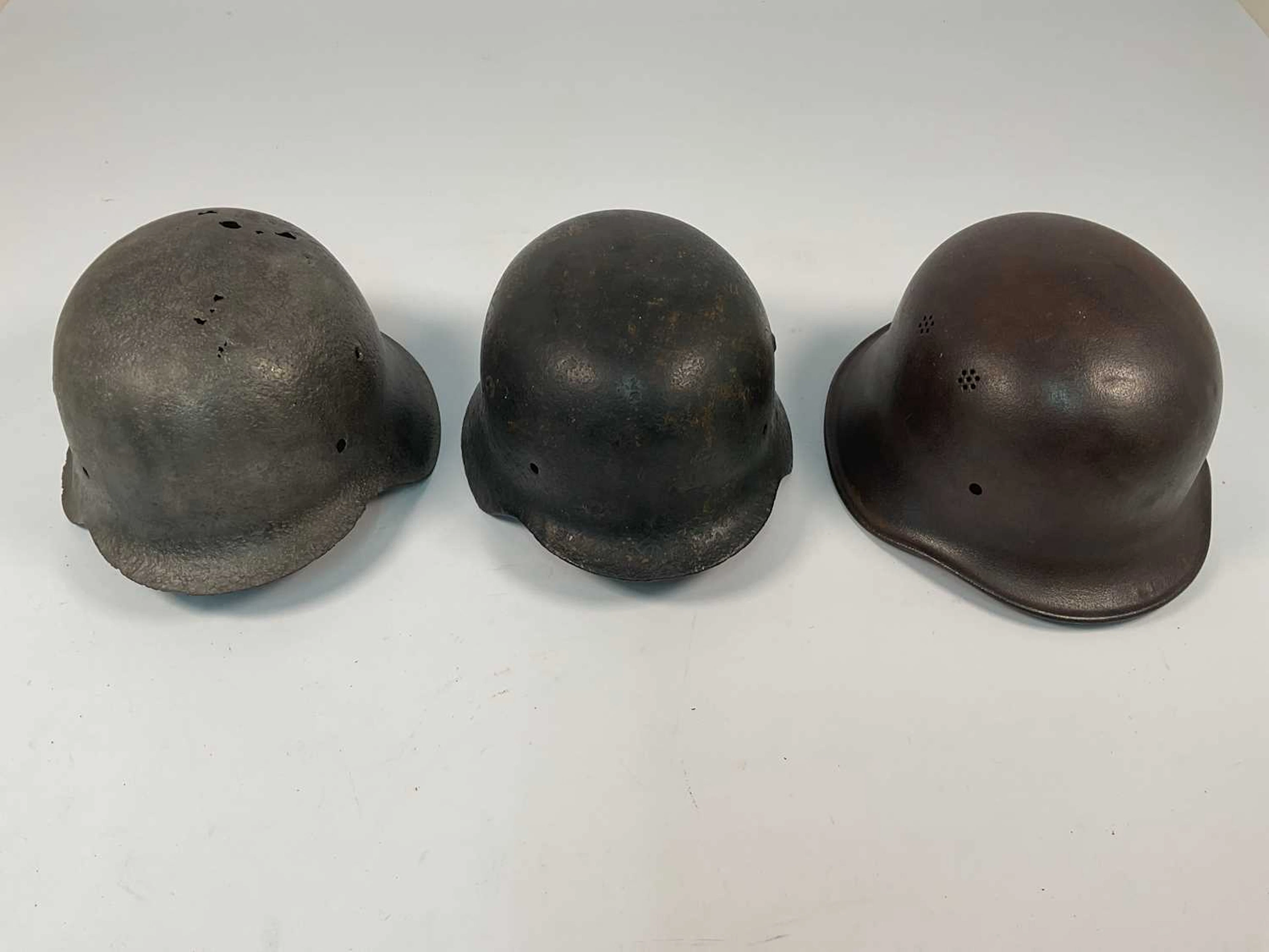 Three WWII German steel helmets