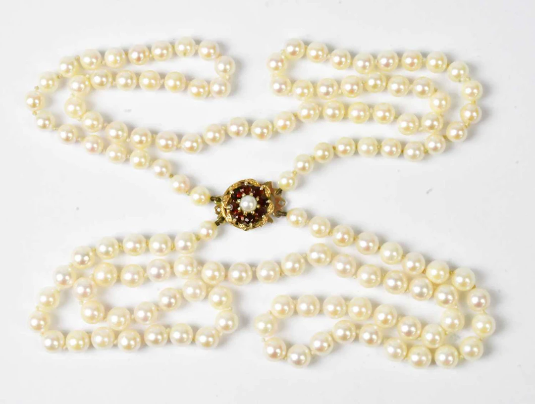 A double-strand pearl necklace with a 9ct yellow gold...