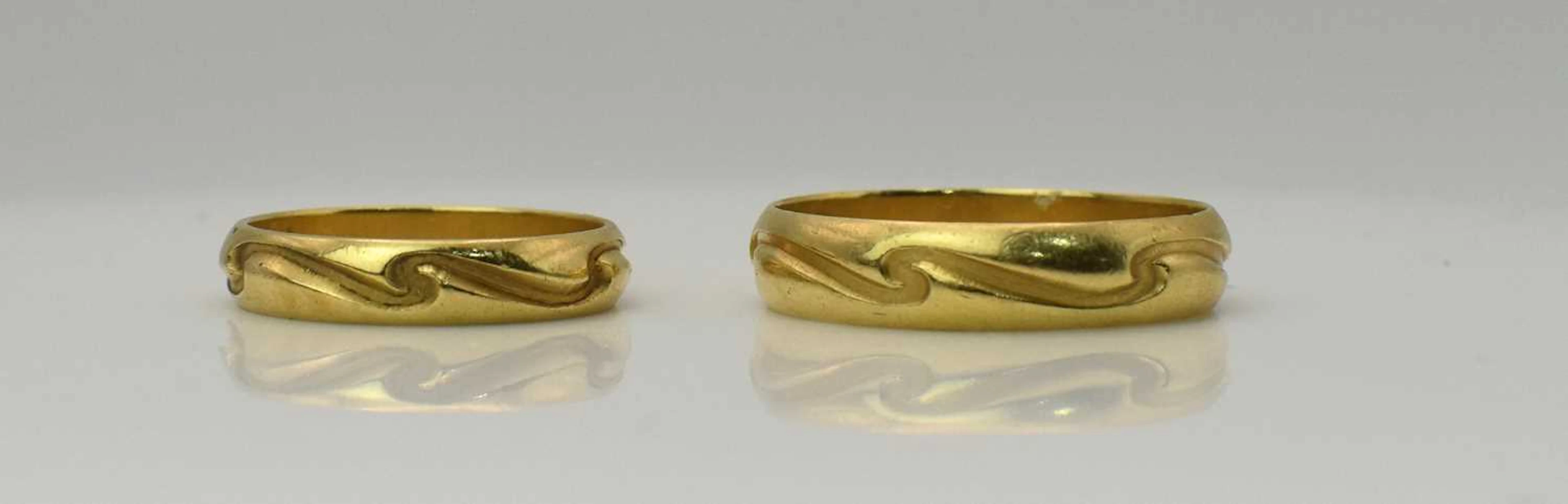 A pair of 18ct yellow gold band rings