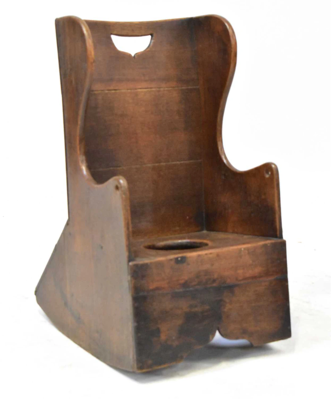 A 19th century child's oak rocking chair/commode