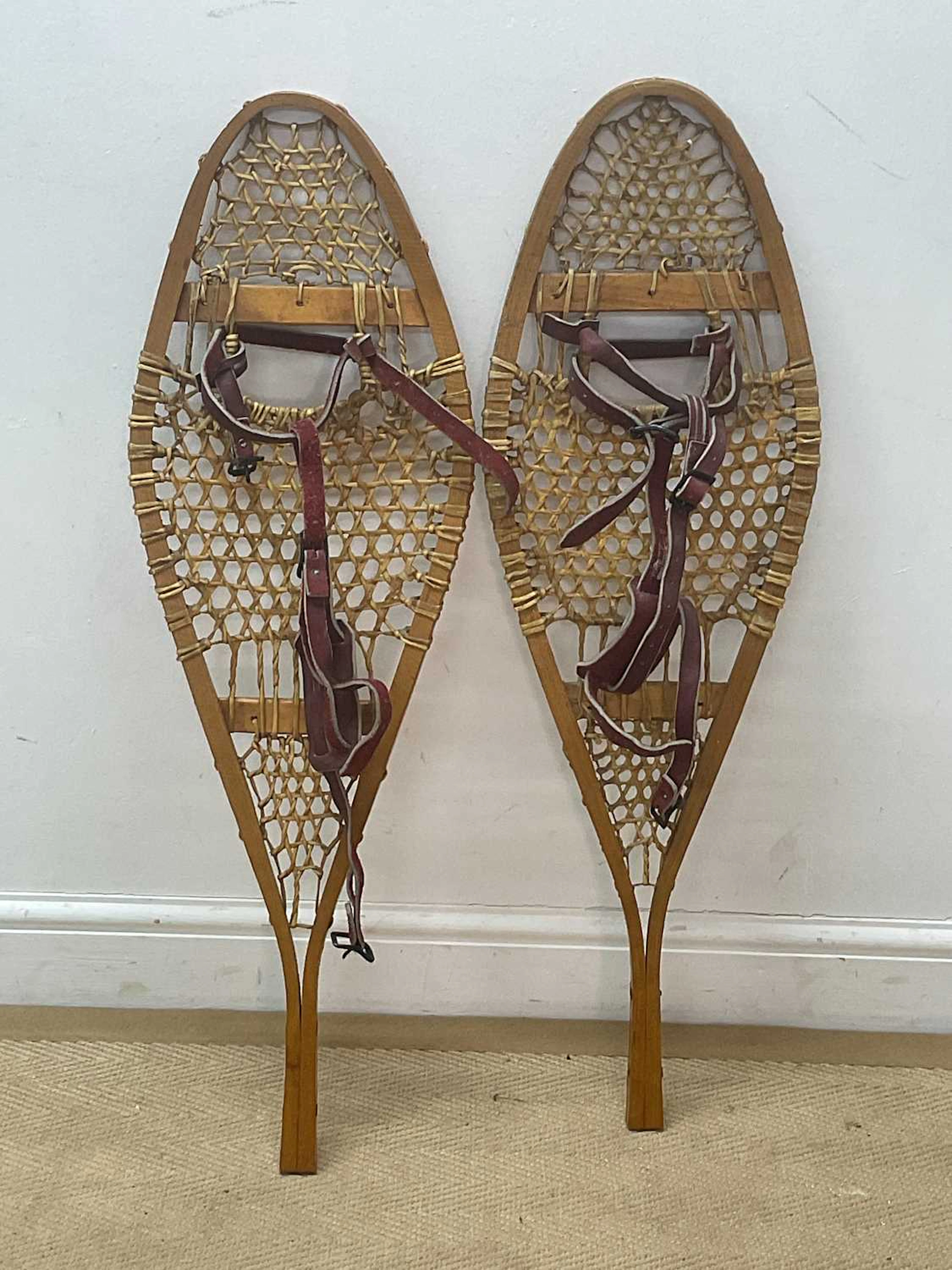 A pair of Canadian snowshoes constructed from ash with...