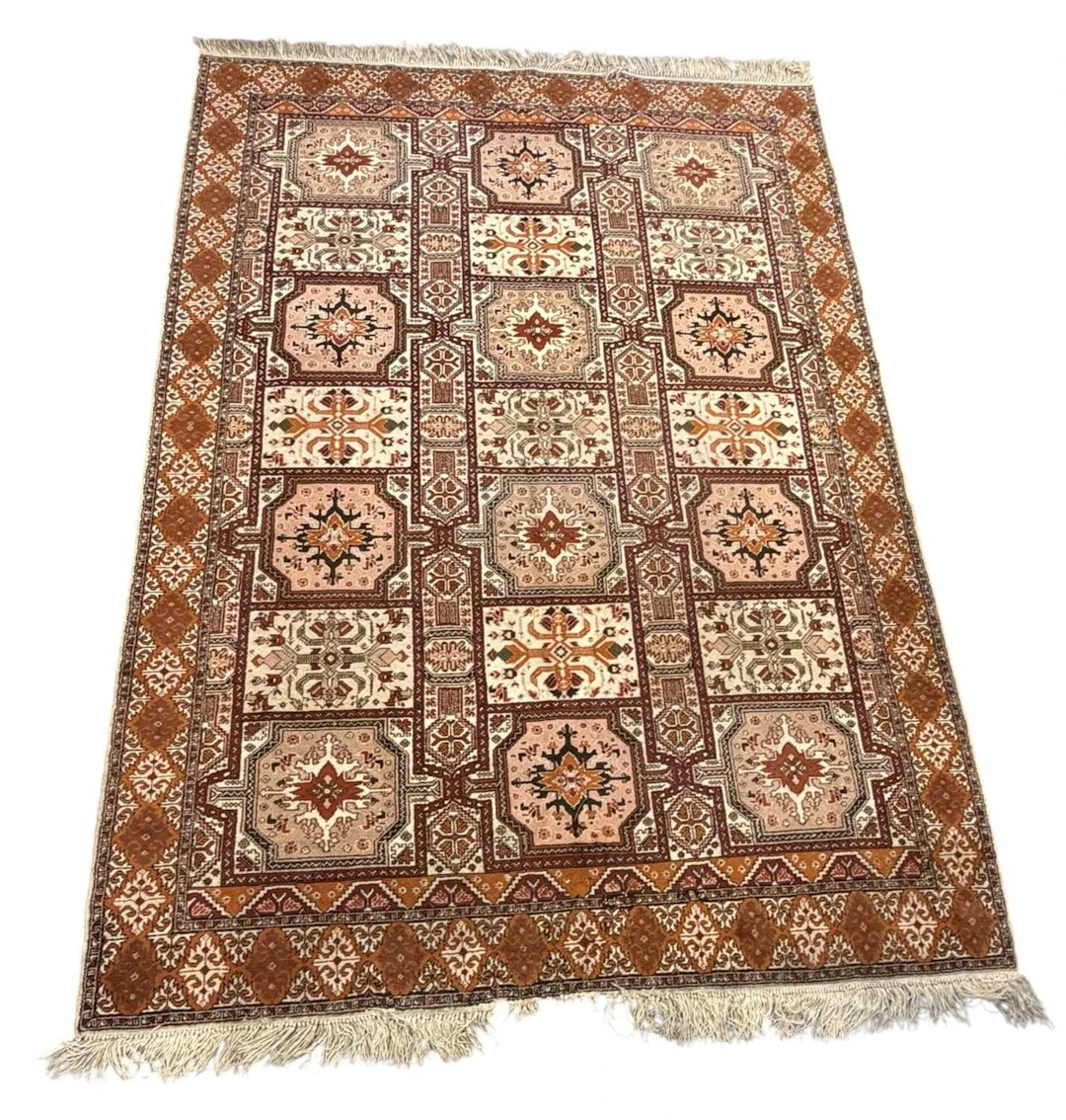 A Moroccan hand woven woollen ground carpet
