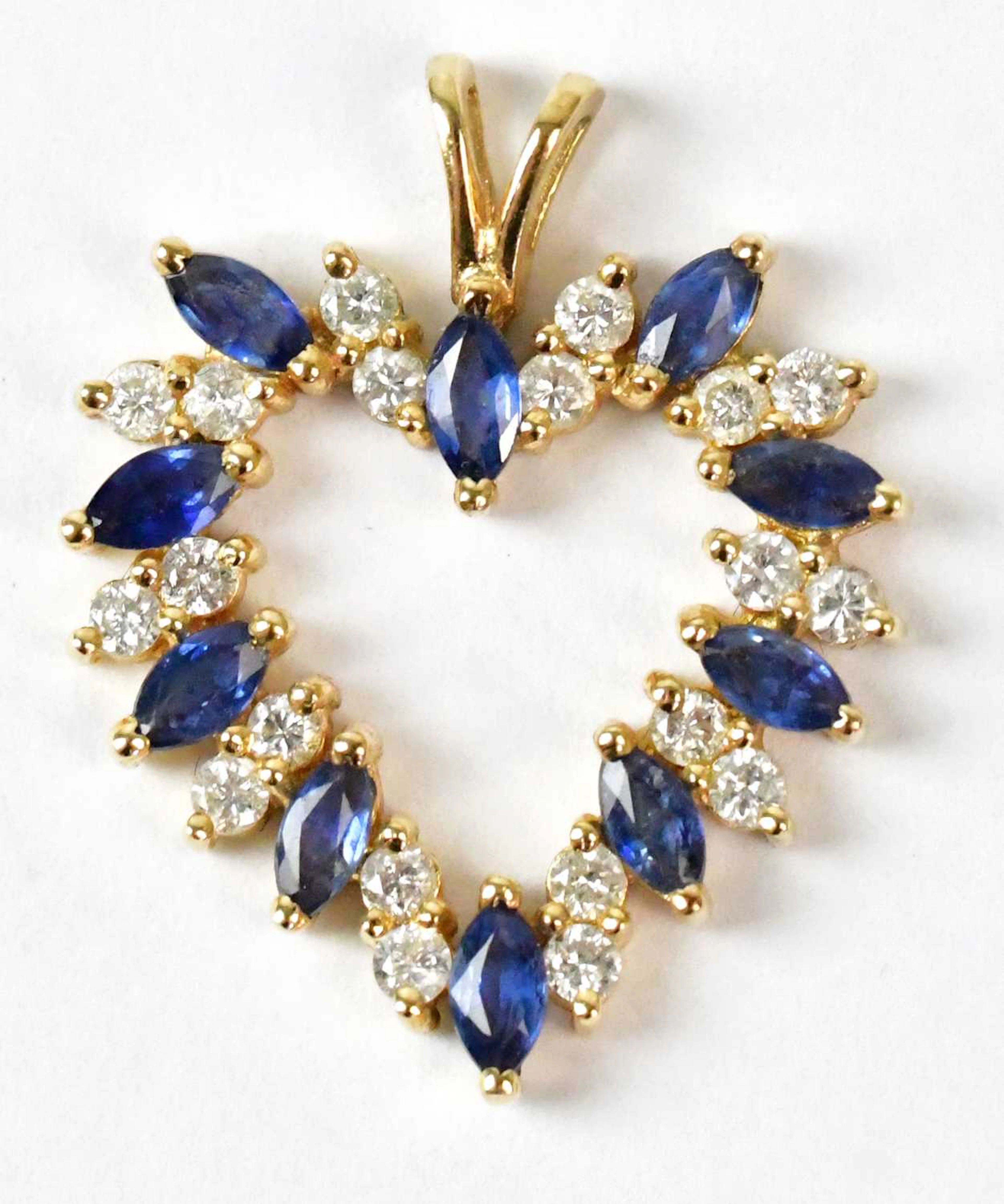 A 14ct yellow gold heart-shaped pendant set with...