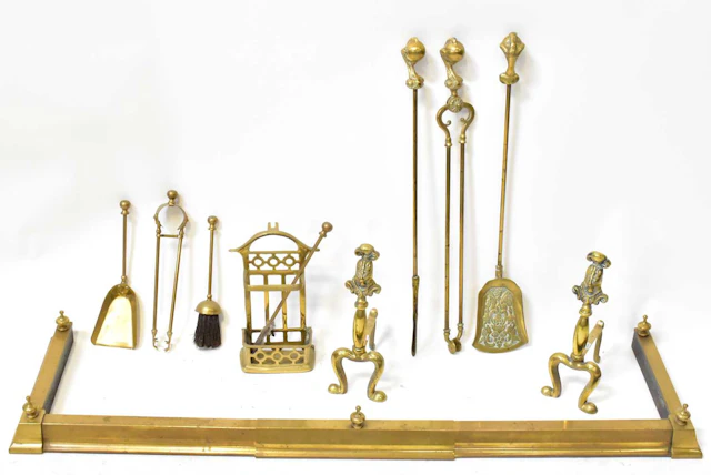 A 19th century extending brass fender with finials