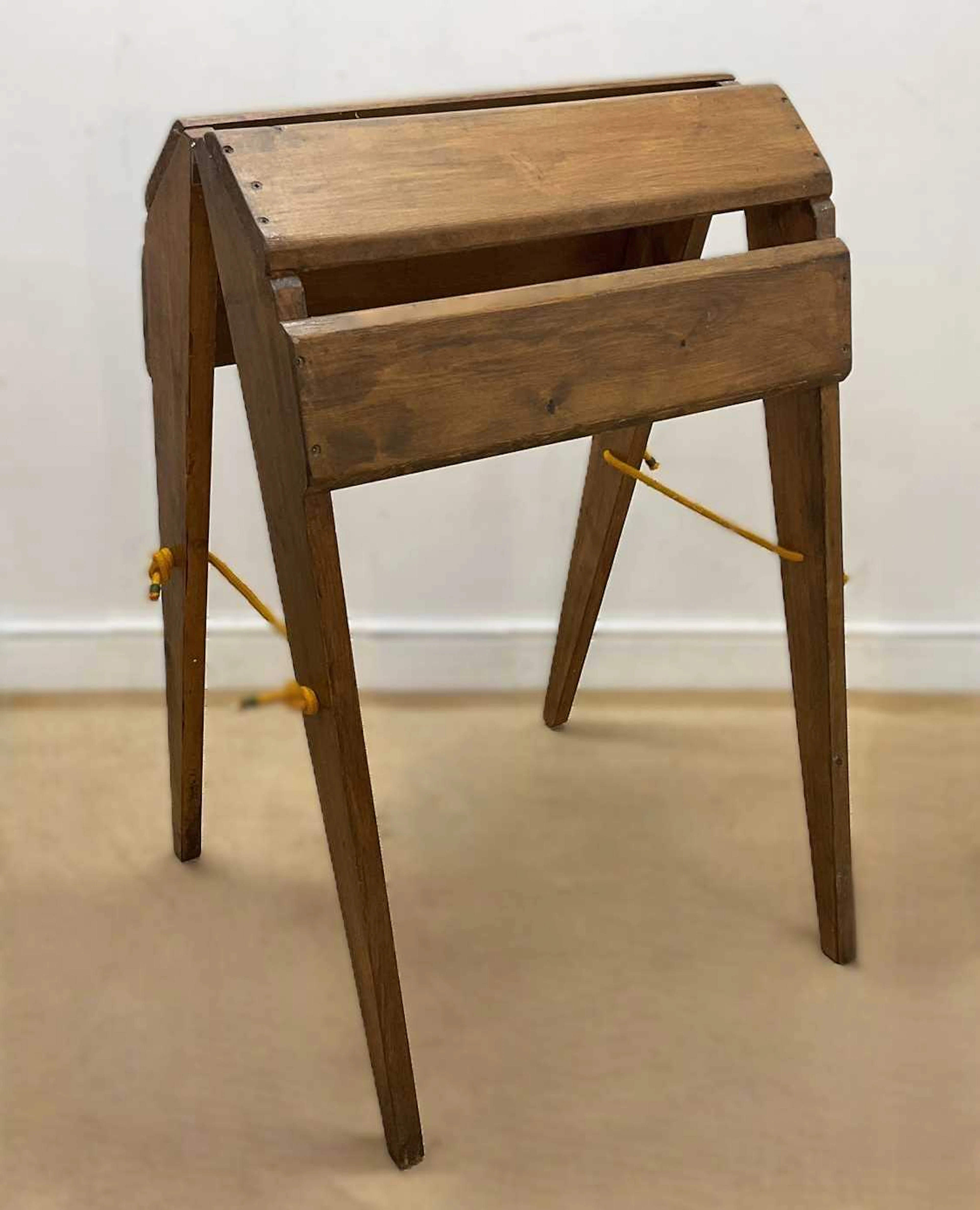 A stained pine folding saddle stand
