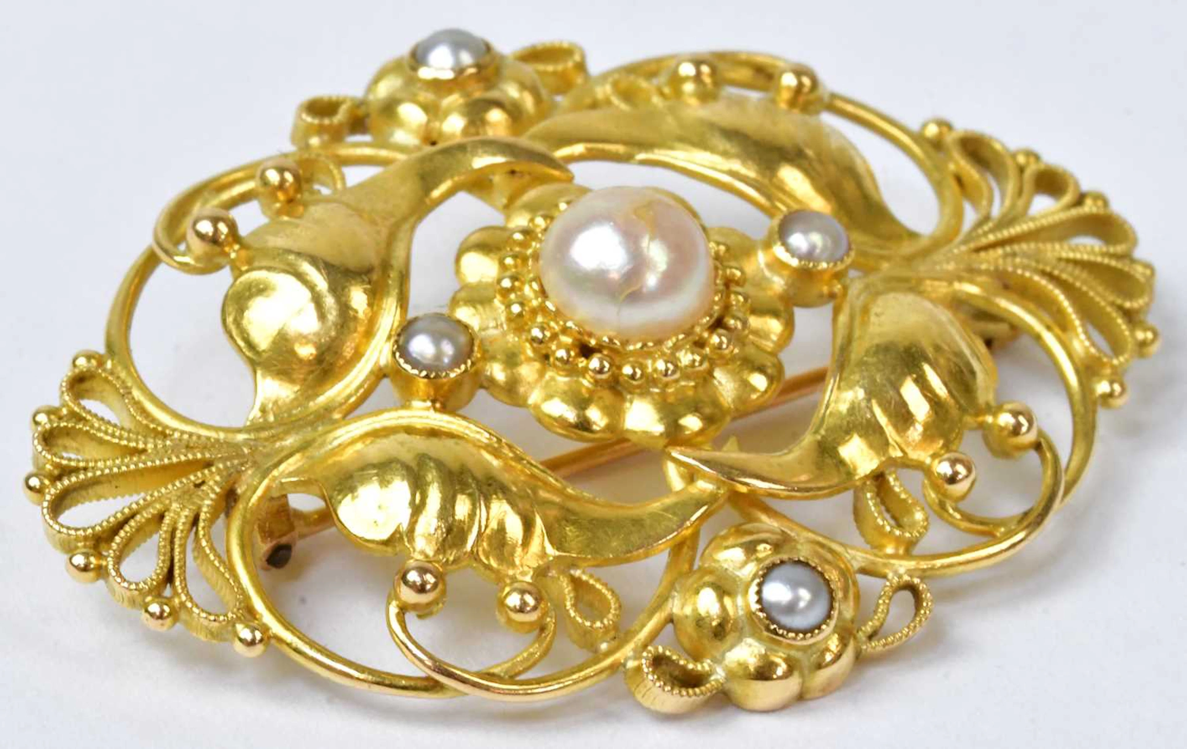 An 18ct yellow gold foliate and floral brooch set with a...