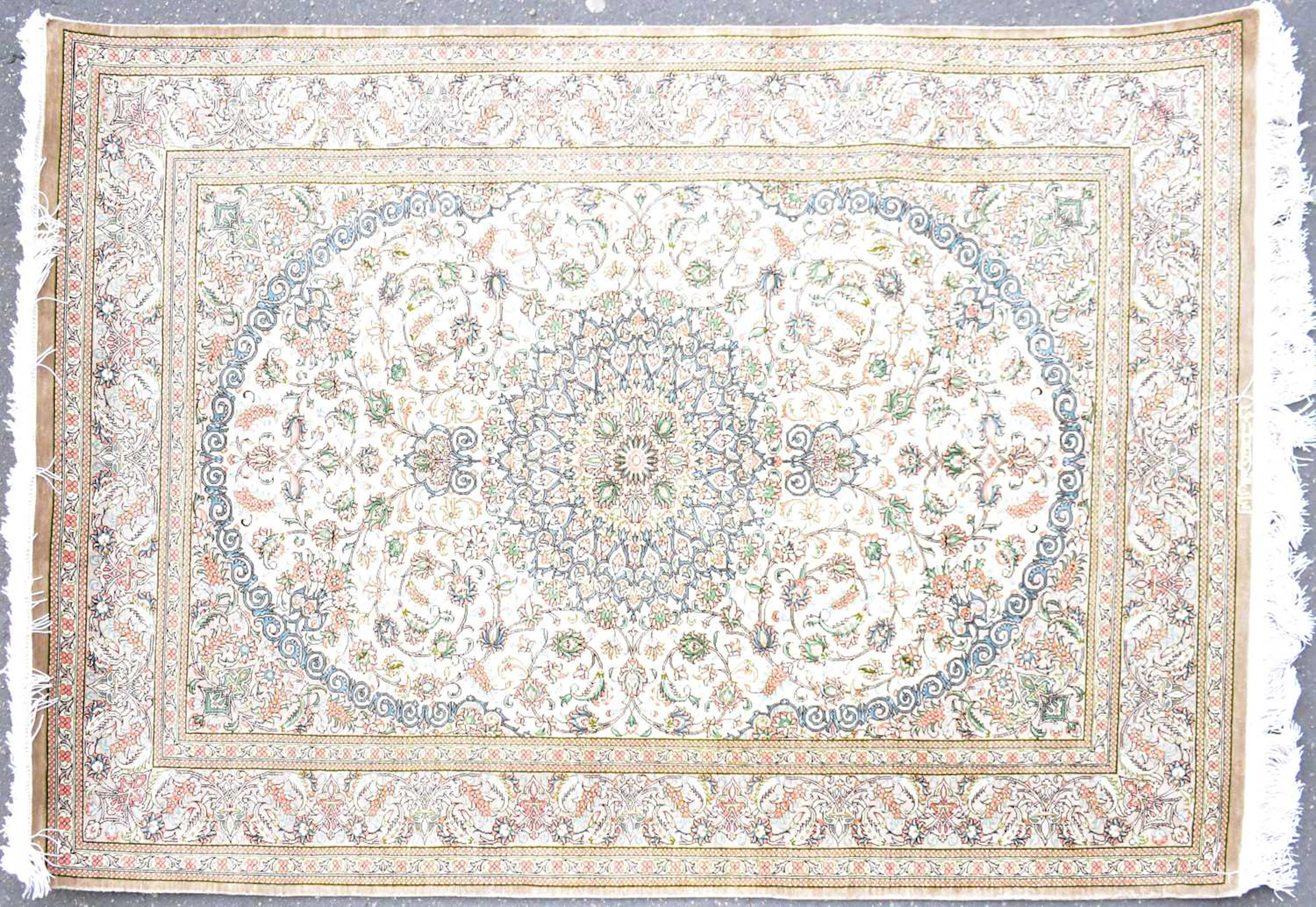 A Persian silk Qum rug with central floral and scrolling...