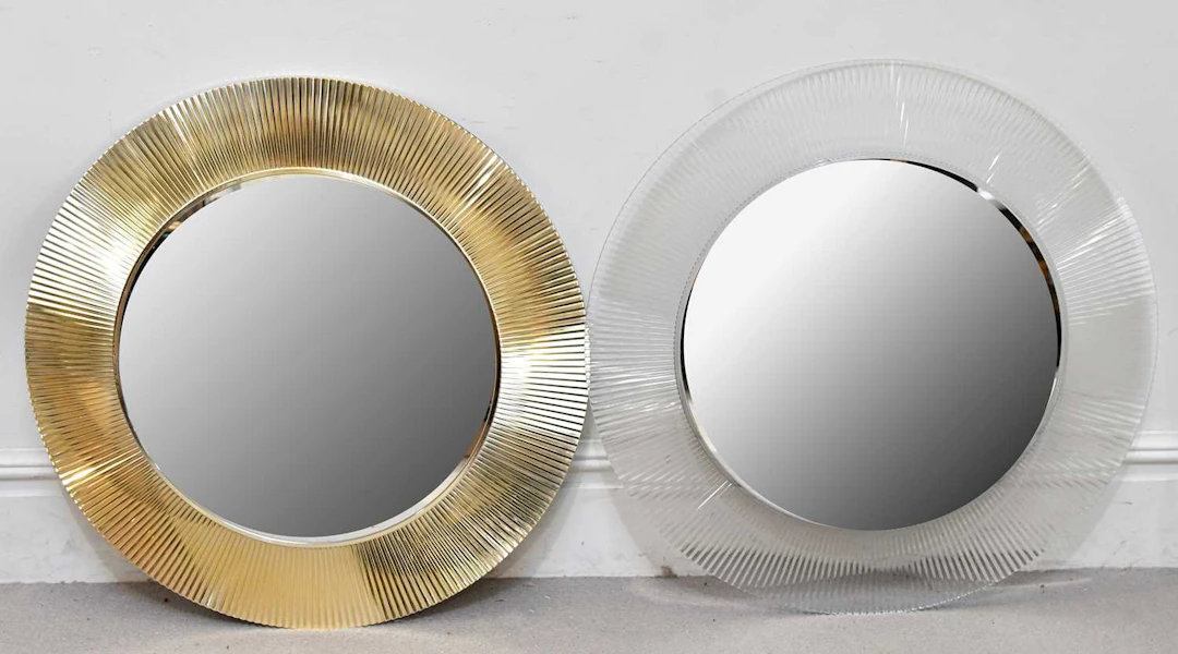 A near pair of modern circular wall mirrors with fluted decoration