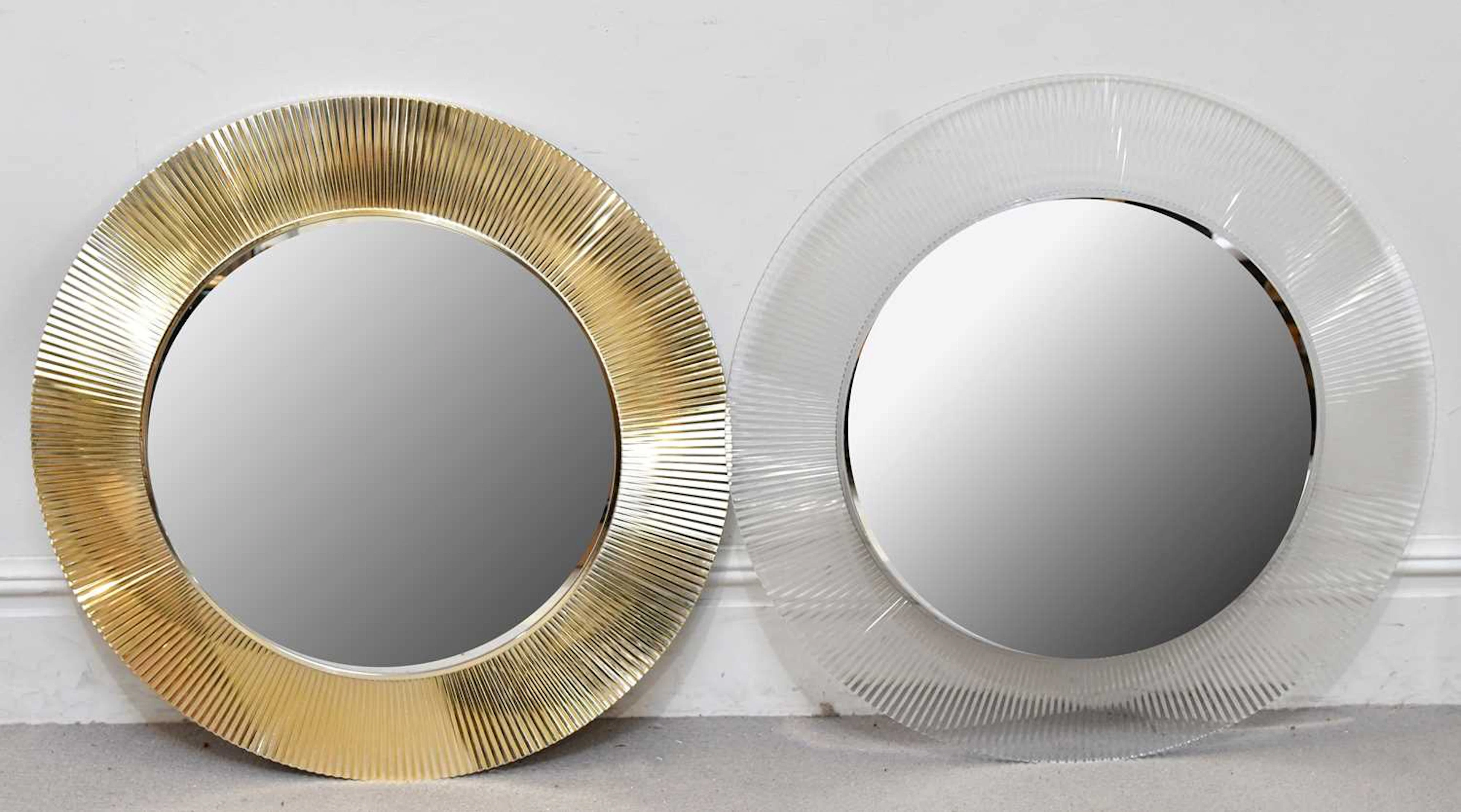 A near pair of modern circular wall mirrors with fluted decoration