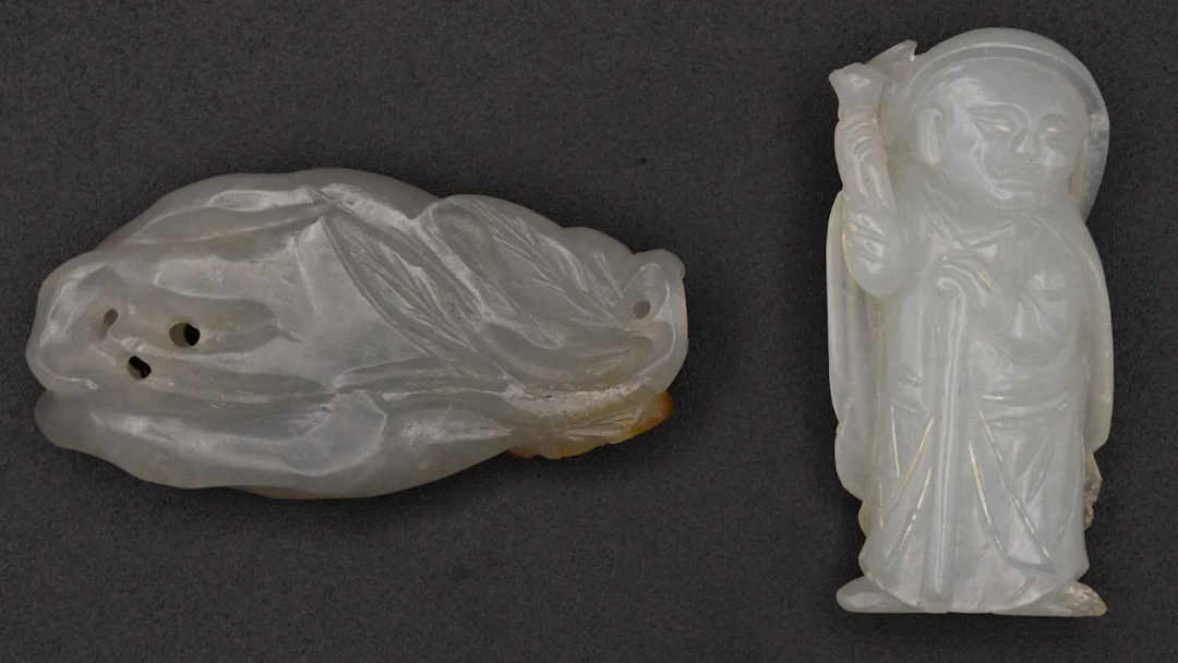 A Chinese carved green jade figure of Buddha