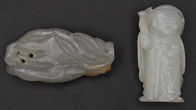 A Chinese carved green jade figure of Buddha