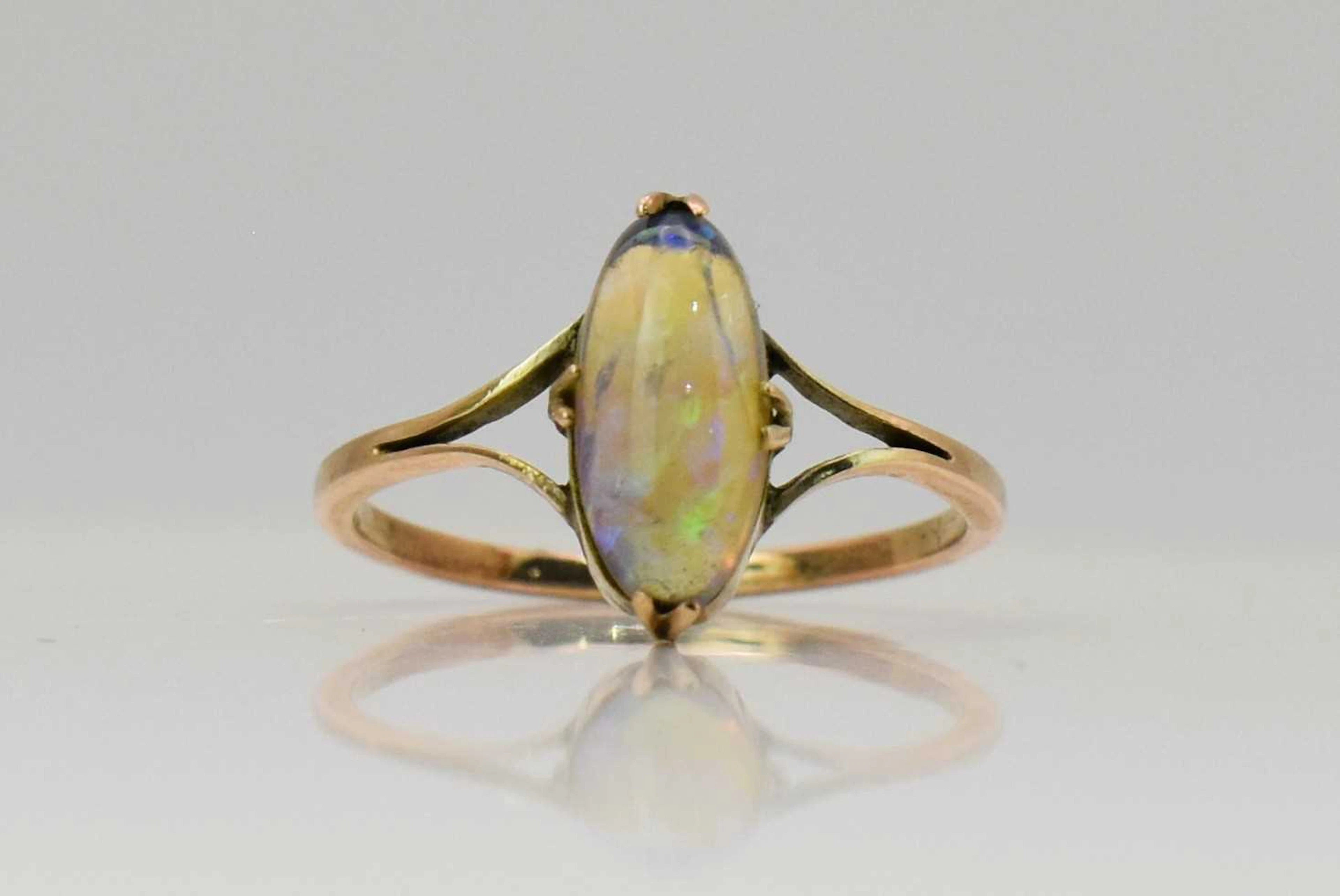 A yellow metal water opal ring