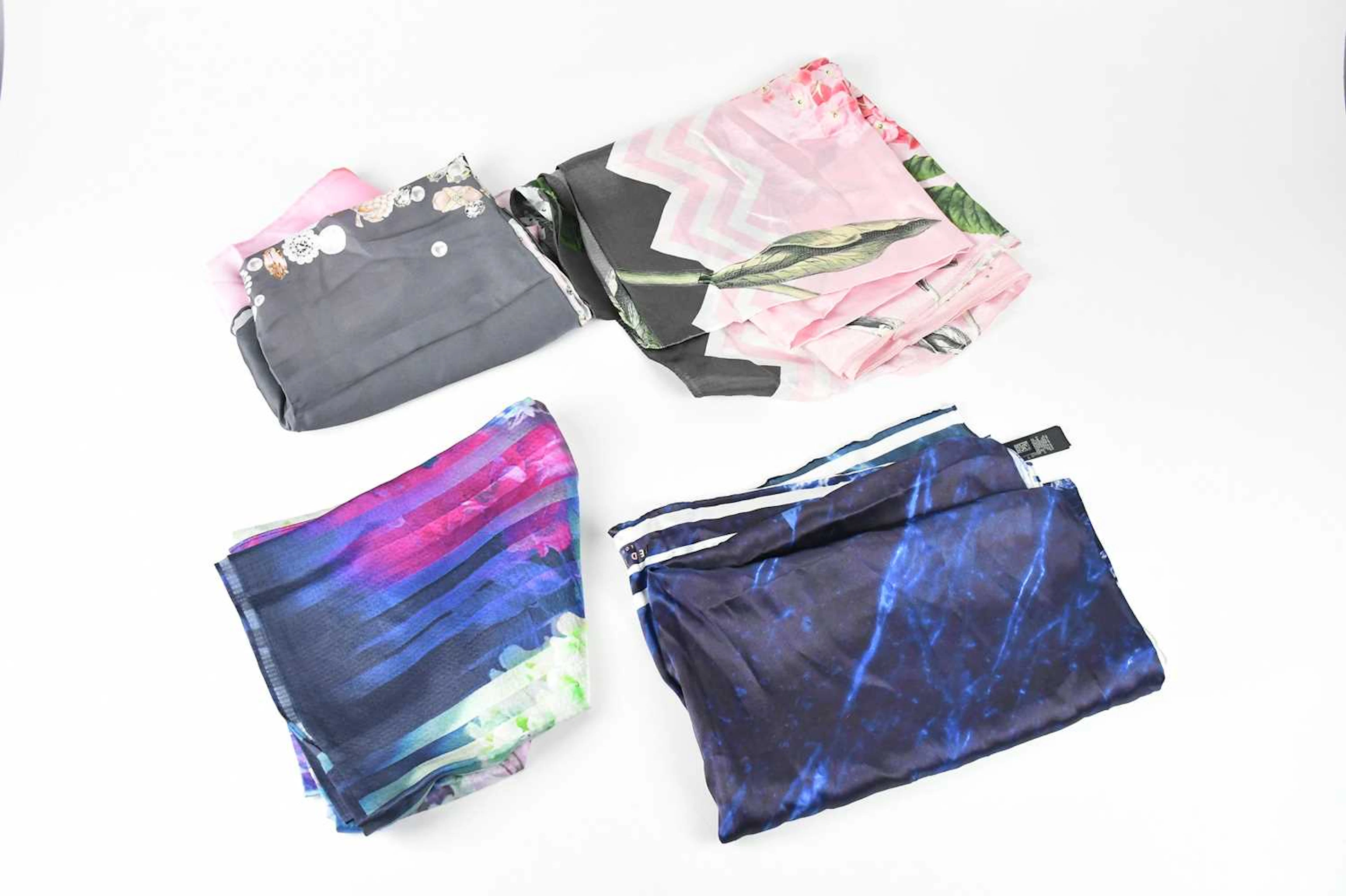 TED BAKER; four 100% silk scarves comprising a pink and...