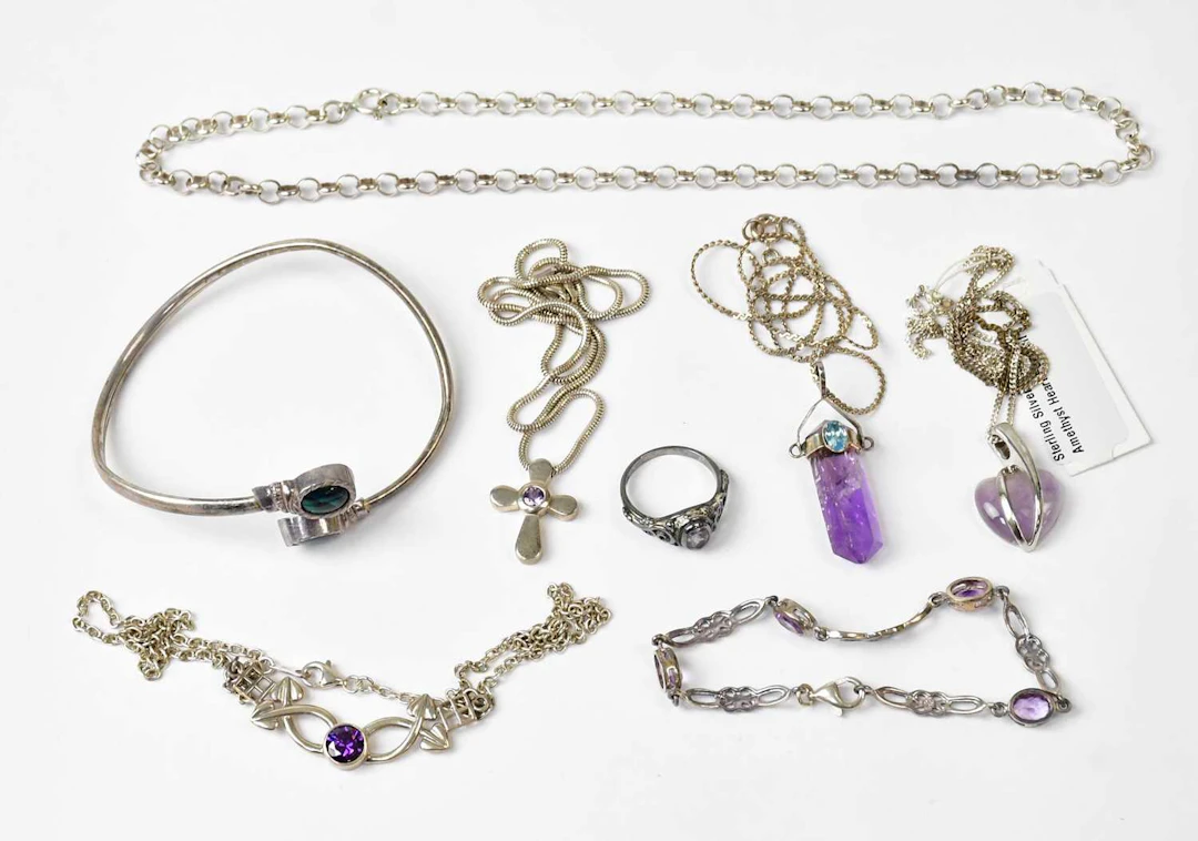 A group of silver jewellery set with purple stones and amethyst