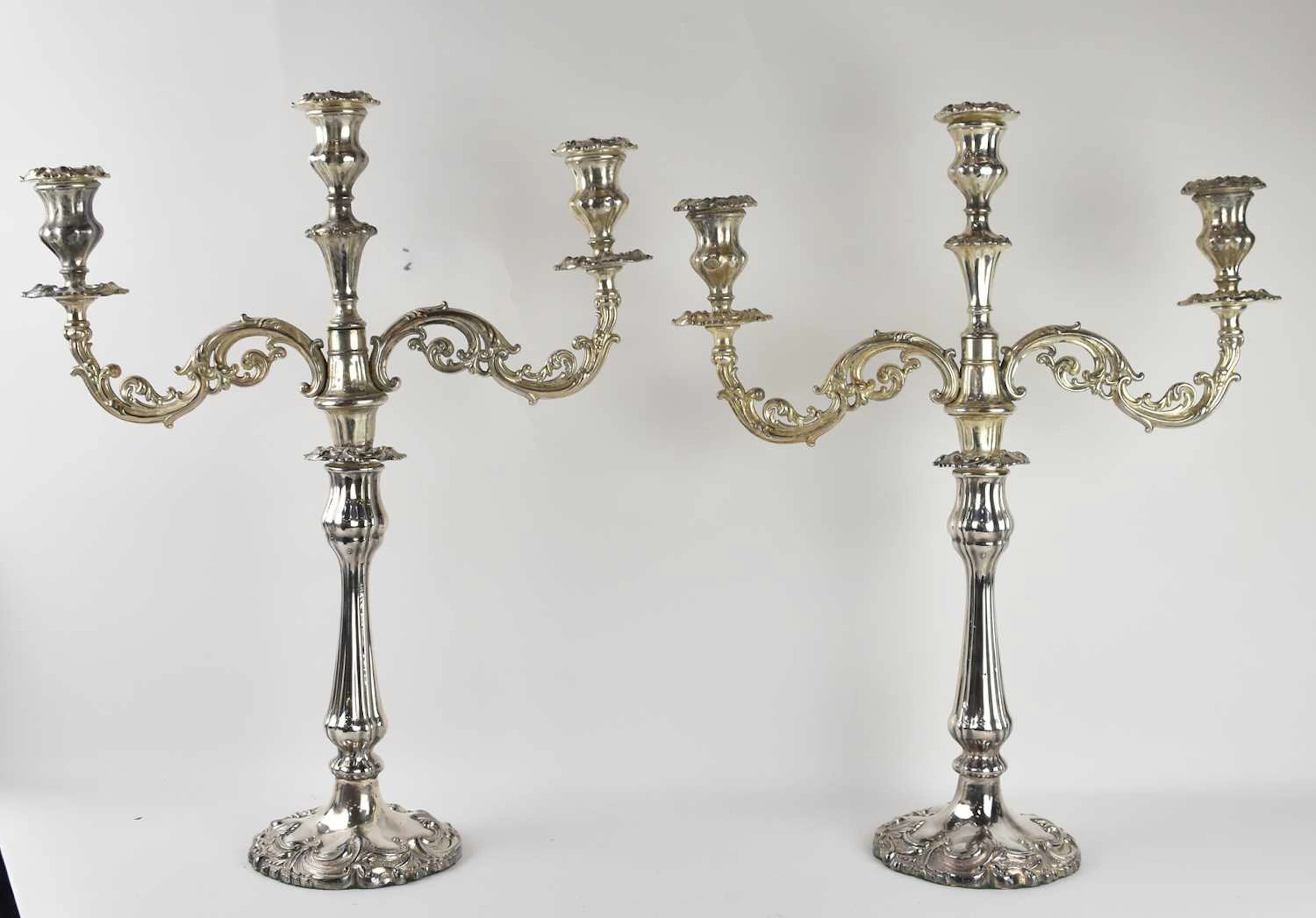 A pair of modern silver plated three branch candelabra
