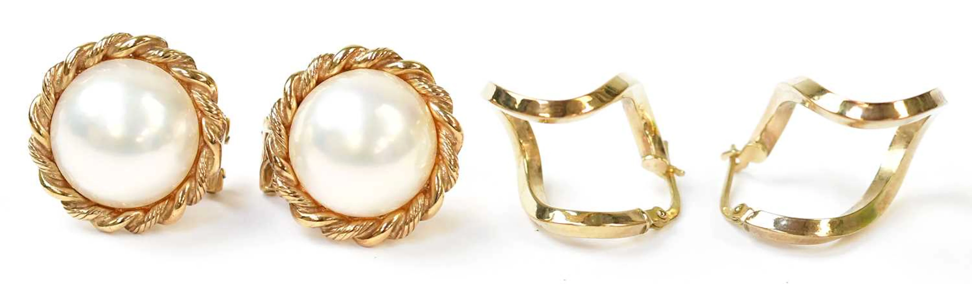 A pair of 9ct yellow gold earrings set with pearls in ropetwist mounts