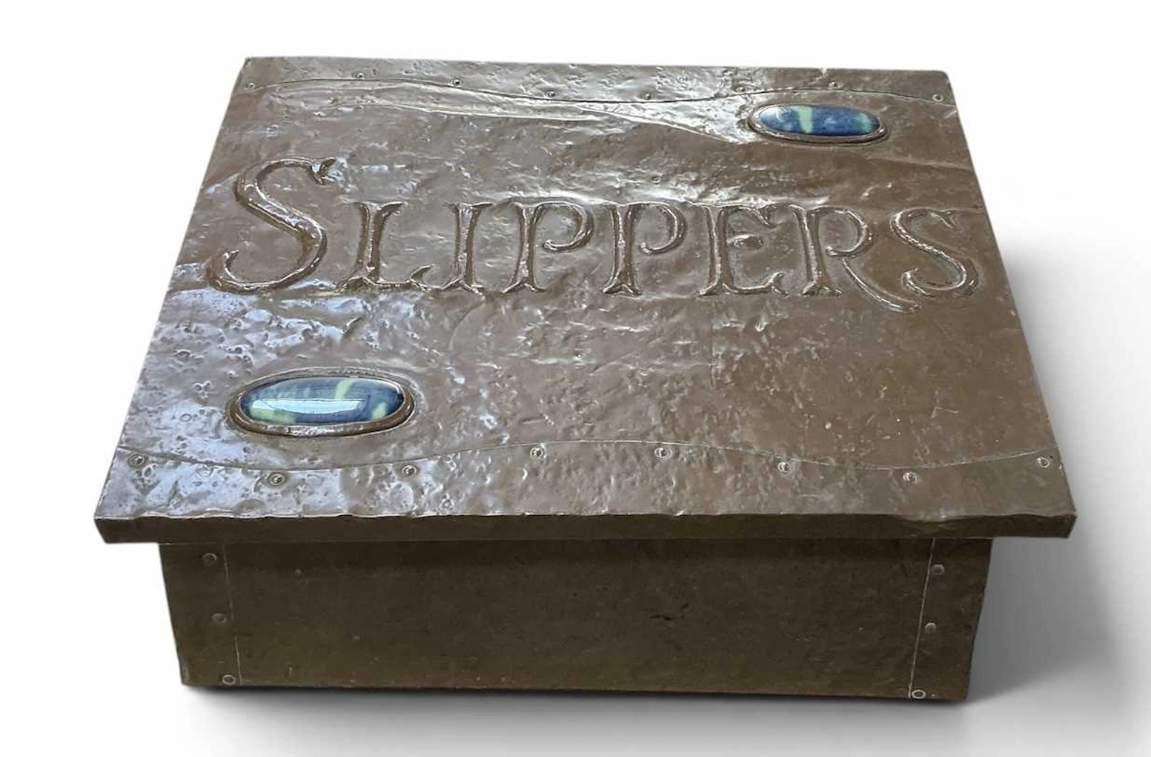 An early 20th century Arts and Crafts copper clad enamelled slipper box