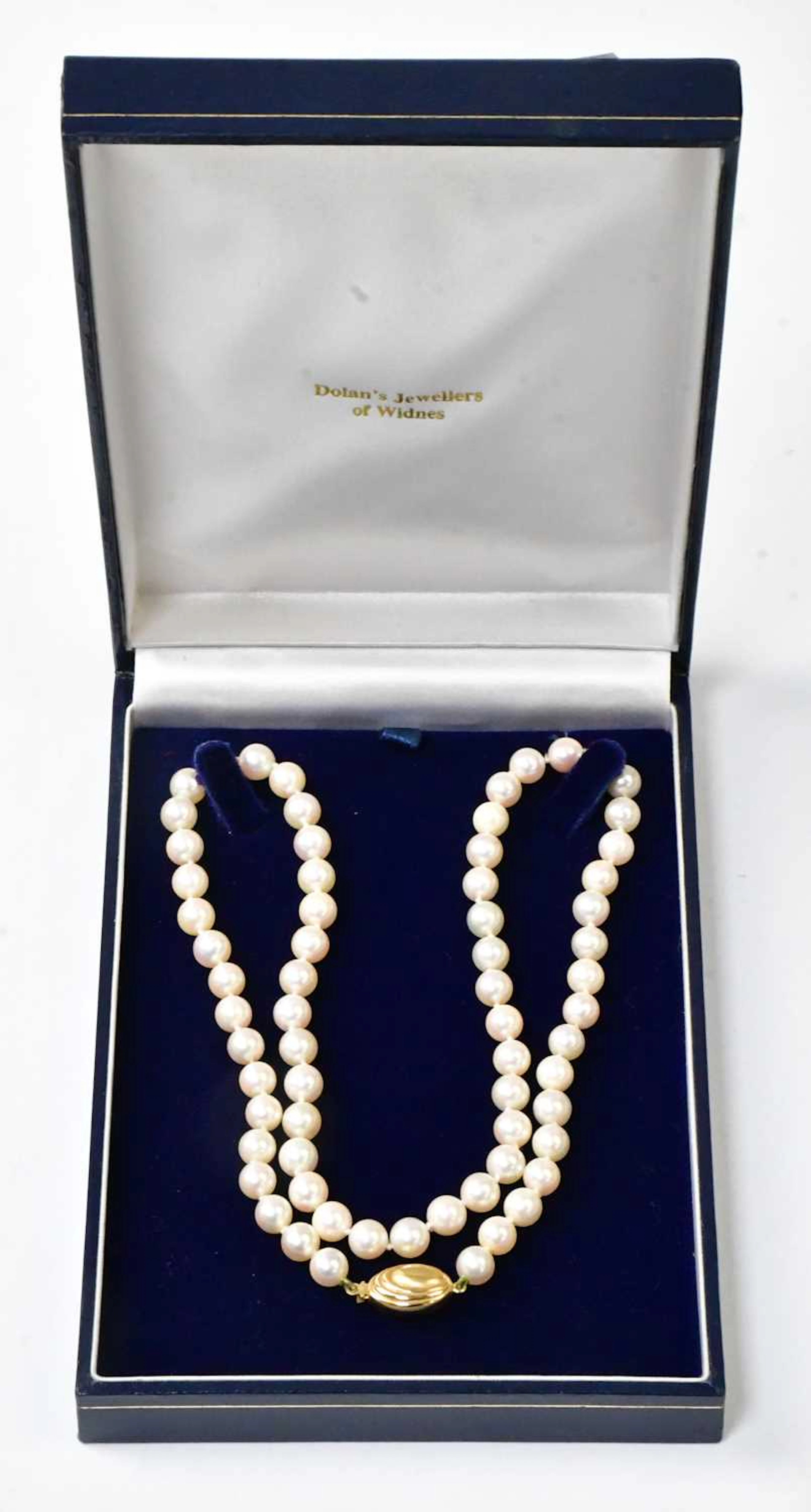 A single-strand pearl necklace with an 18ct yellow gold oval clasp
