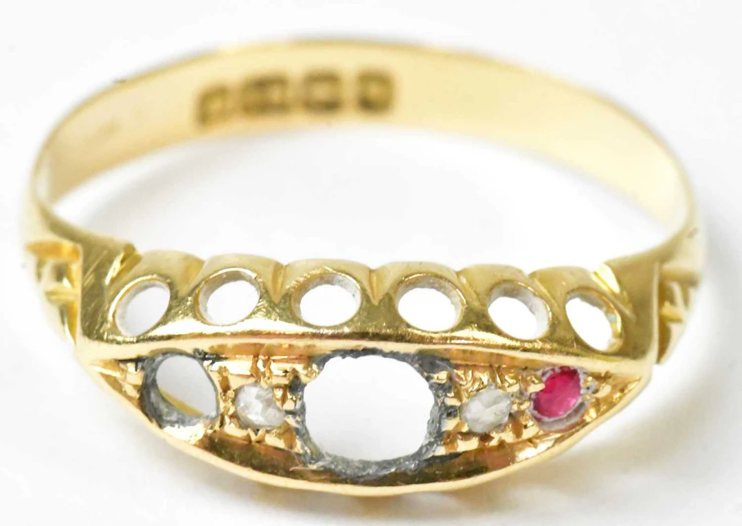 An 18ct yellow gold ring set with two tiny white stones...