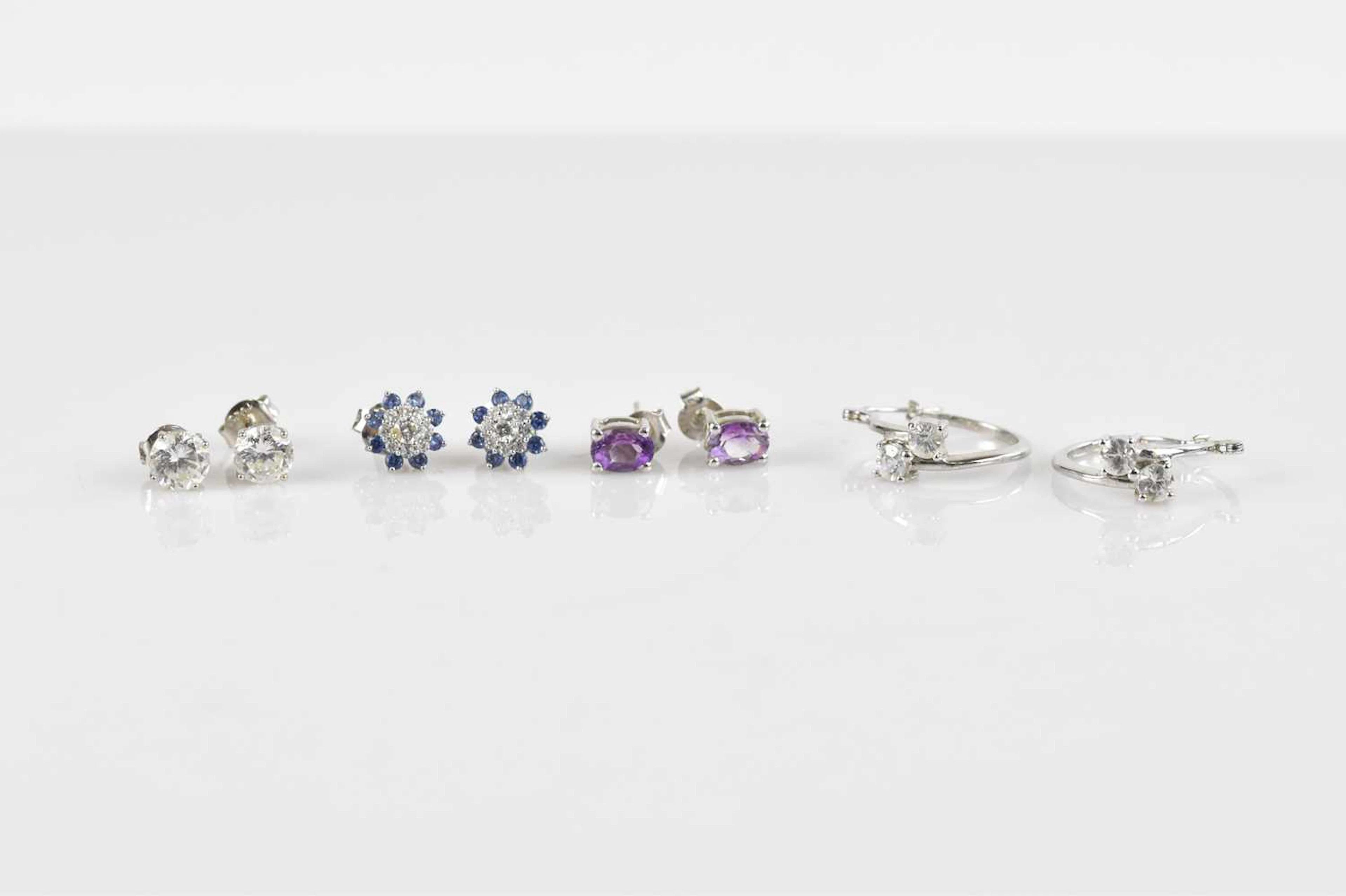 Four pairs of sterling silver ear studs/hoop earrings