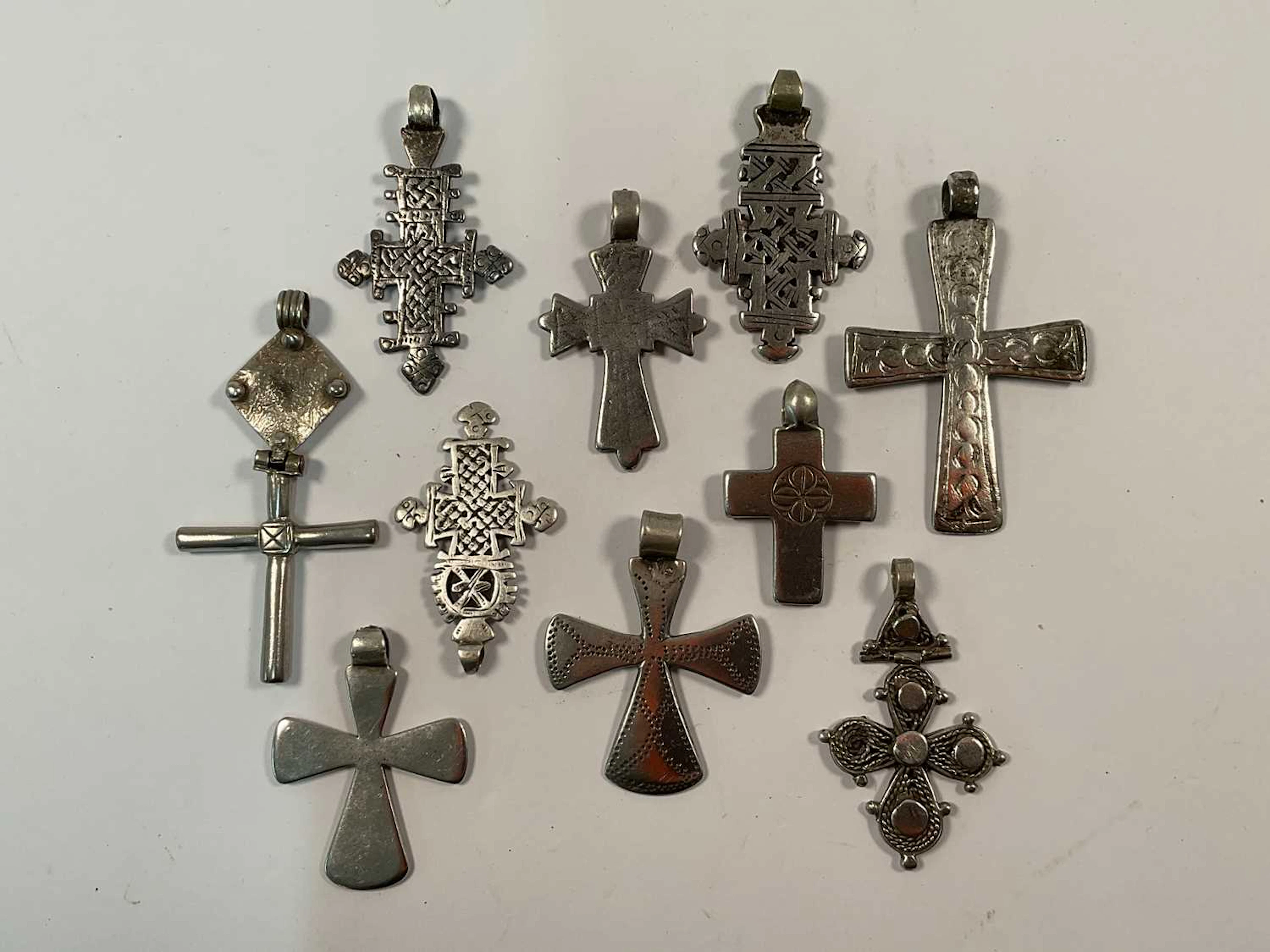 Ten Ethiopian metal Coptic crosses of various styles