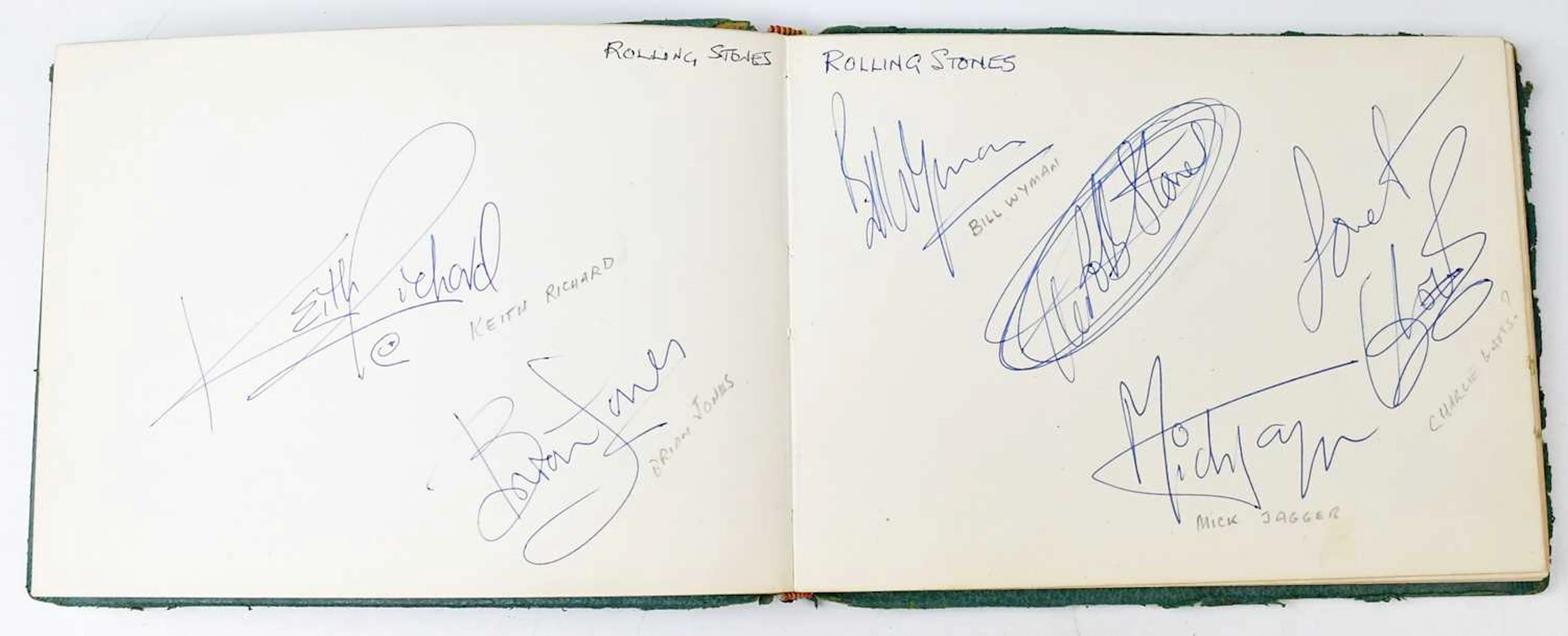 A vintage green autograph book containing a large quantity of autographs