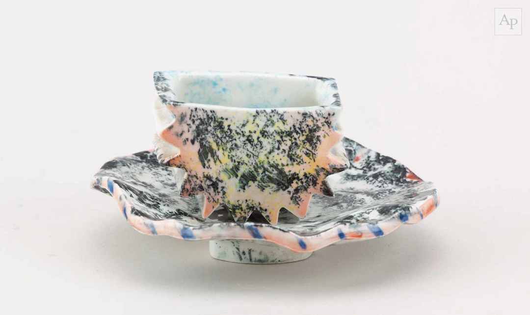CAROL McNICOLL (1943-2025); a porcelain espresso cup and...