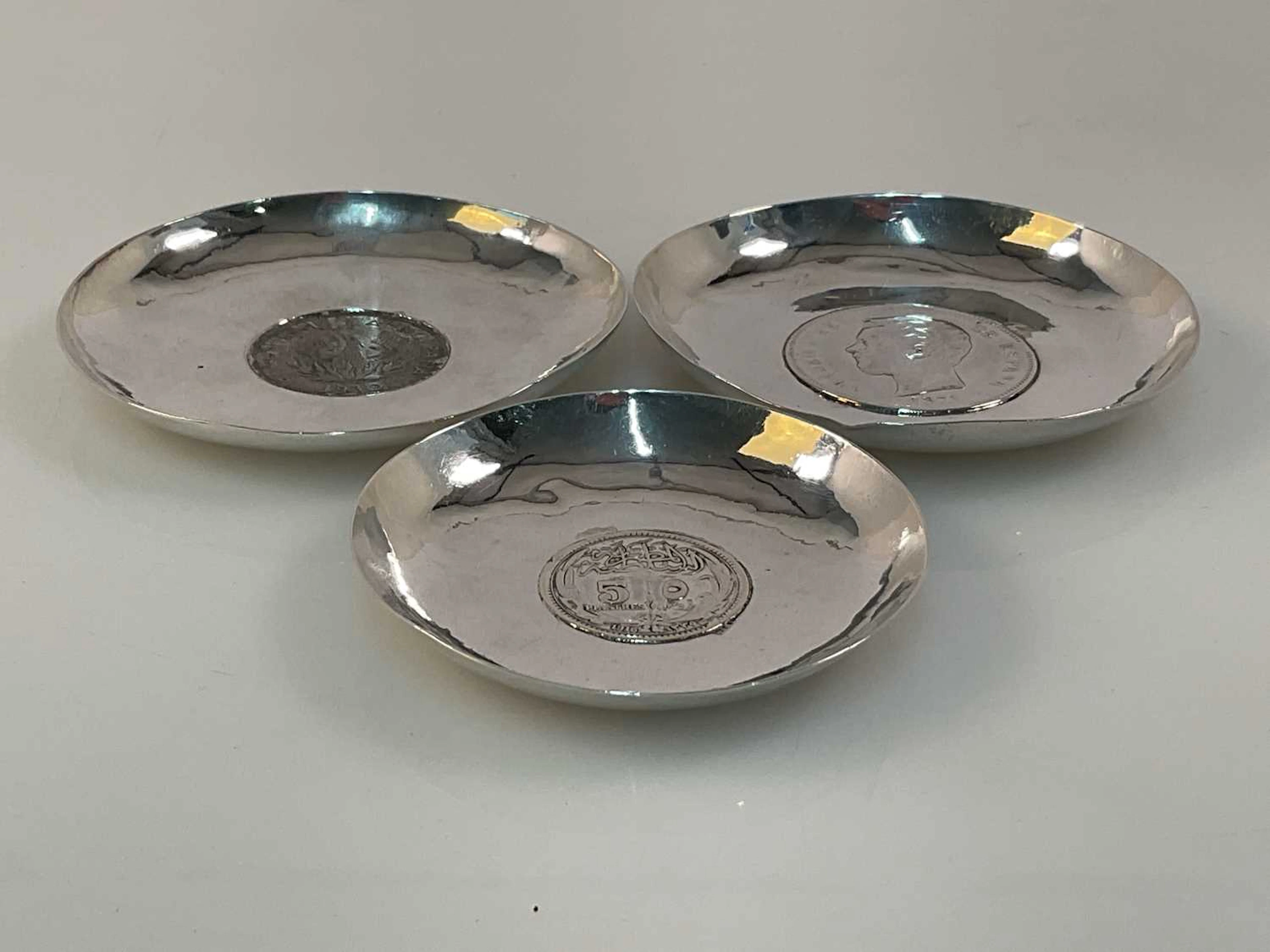 Three white metal coin dishes