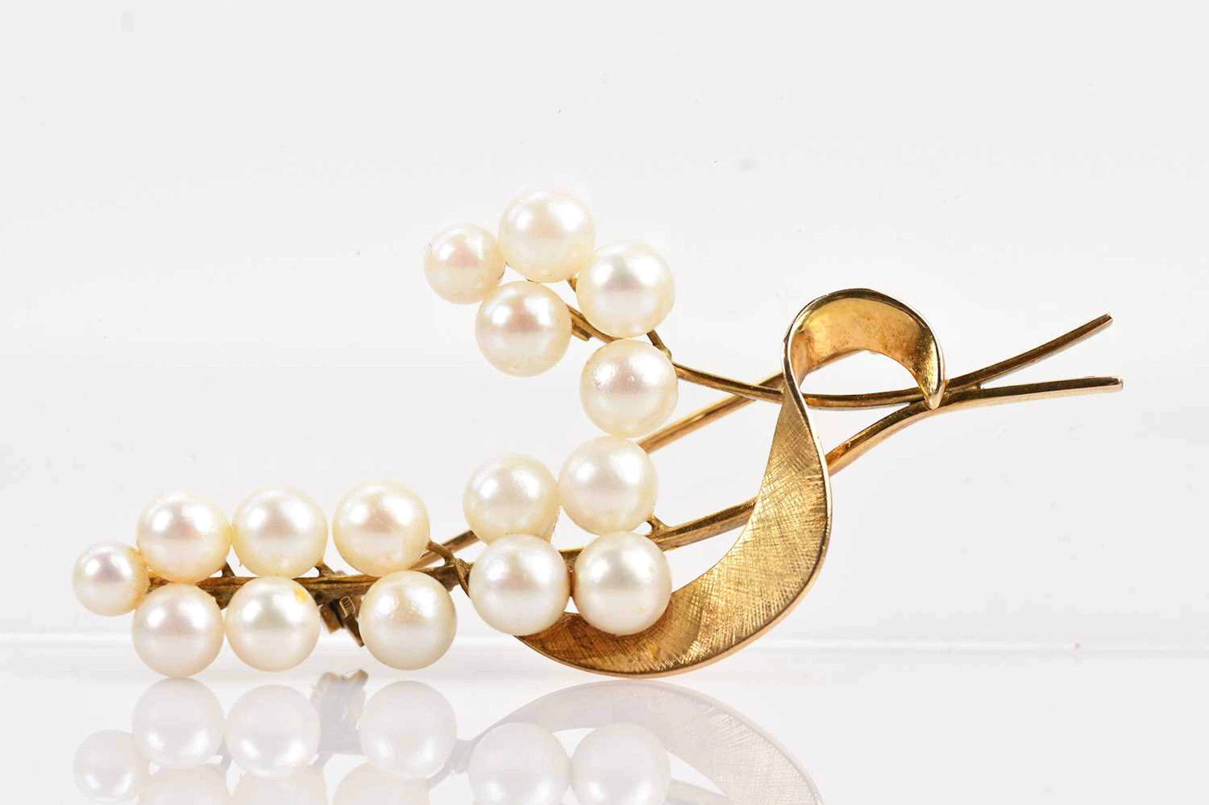 A Japanese pearl set leaf brooch