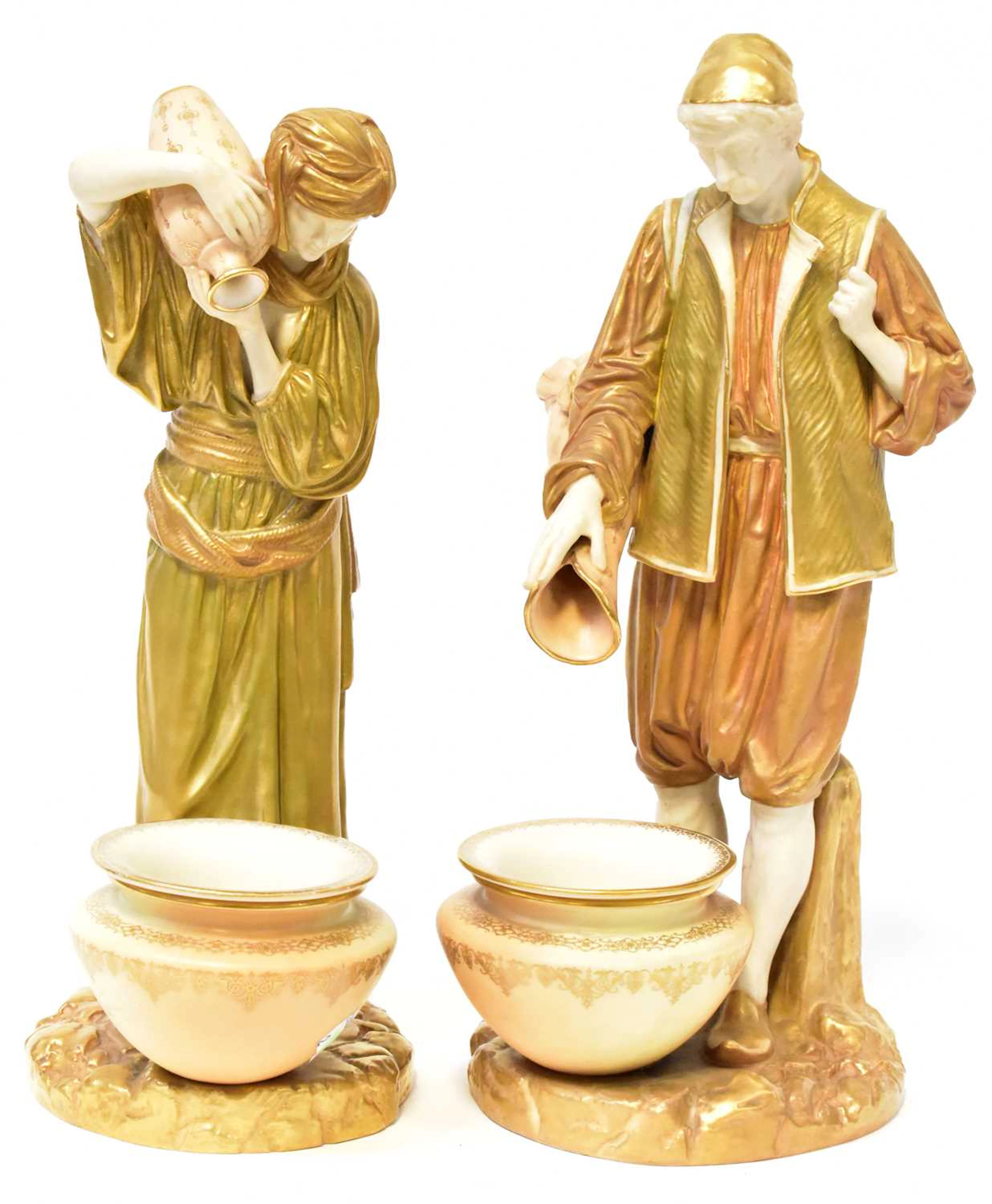 ROYAL WORCESTER; a pair of James Hadley figures of water carriers