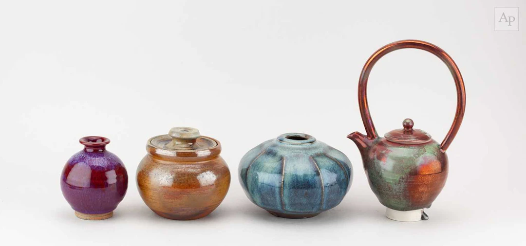 MARK GRIFFITHS (born 1956); a faceted vase covered in chun and iron glaze