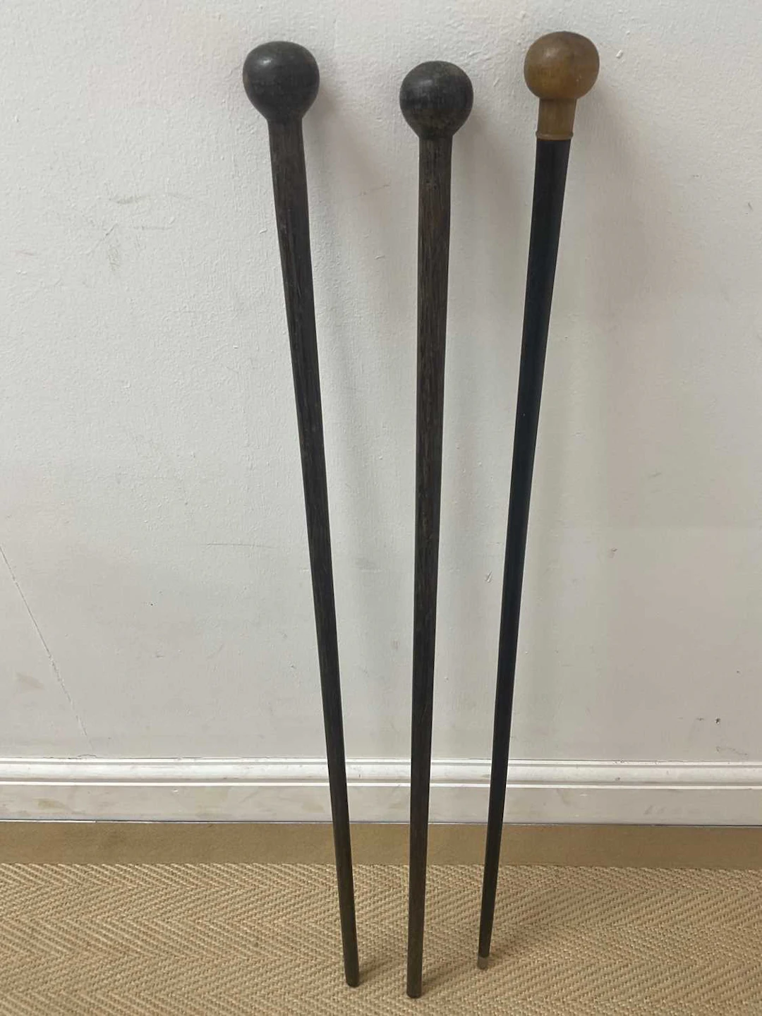 Three hardwood walking sticks