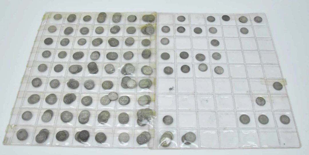 Approximately two hundred and three silver and half silver three pence coins