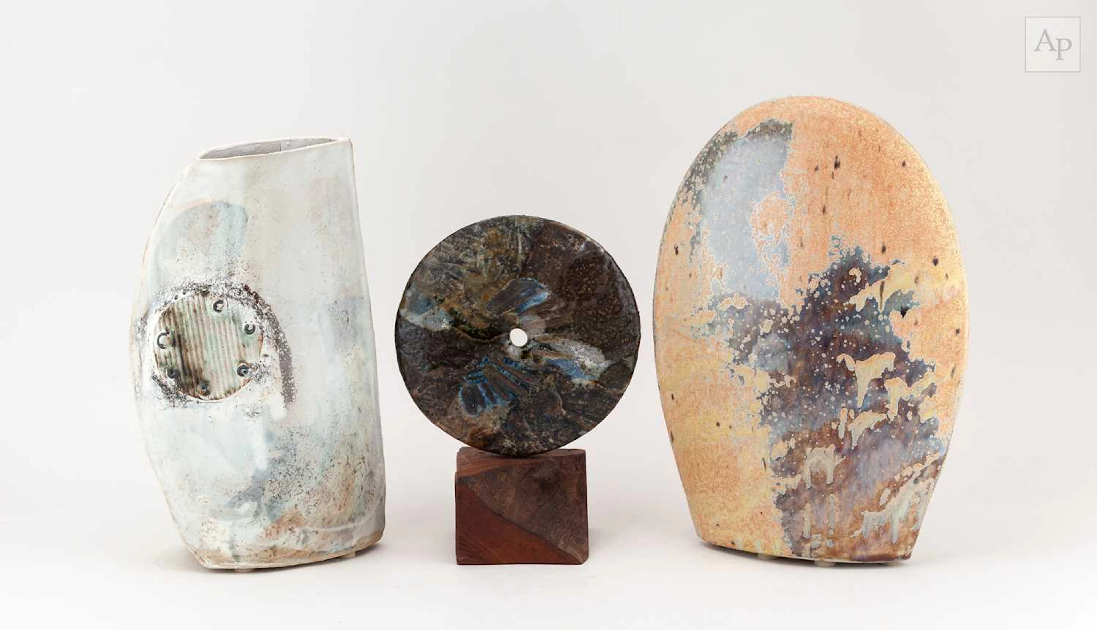 NICHOLAS MARSH; a raku disc on a wooden base covered in...