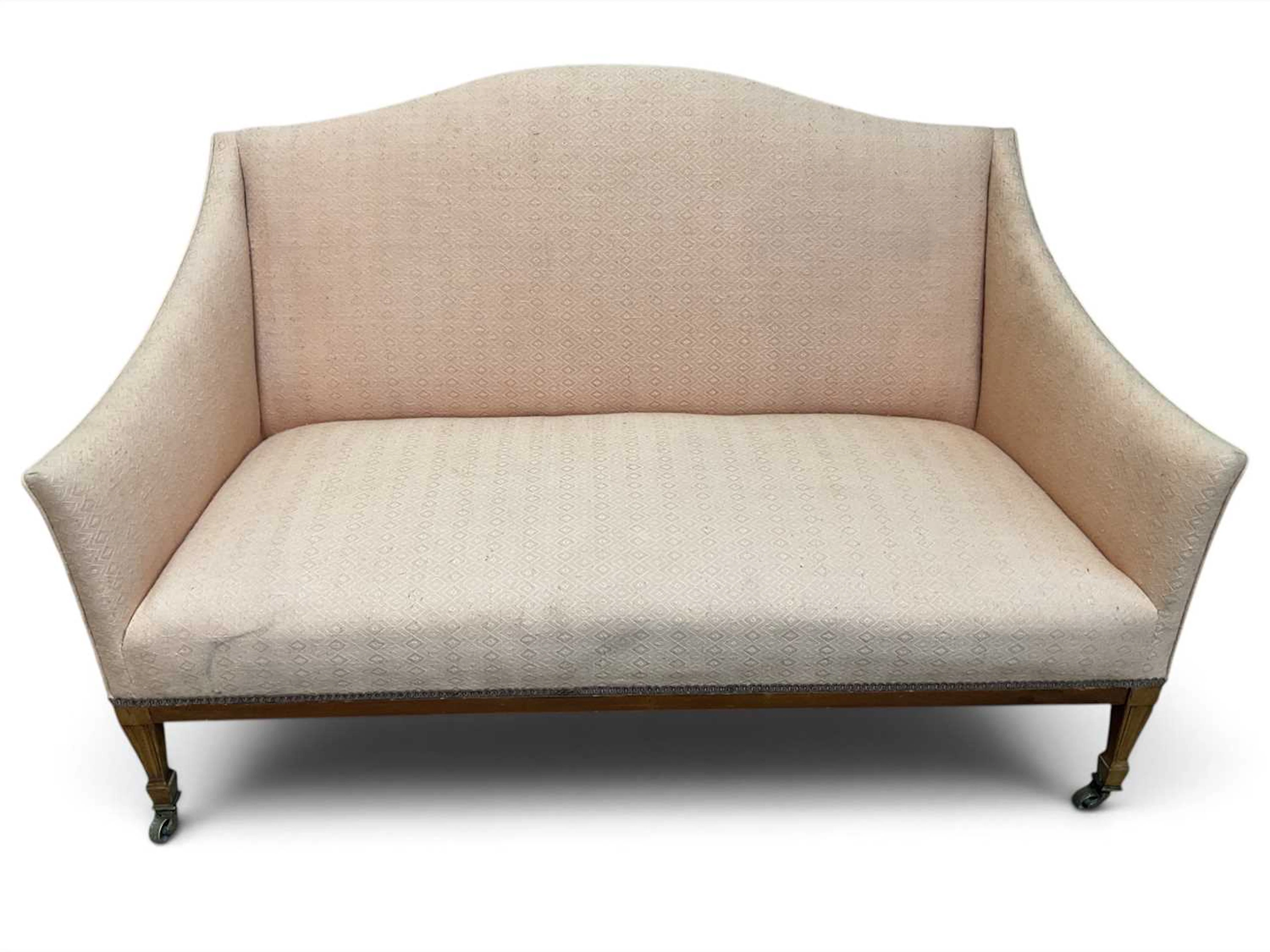 An Edwardian mahogany salon sofa