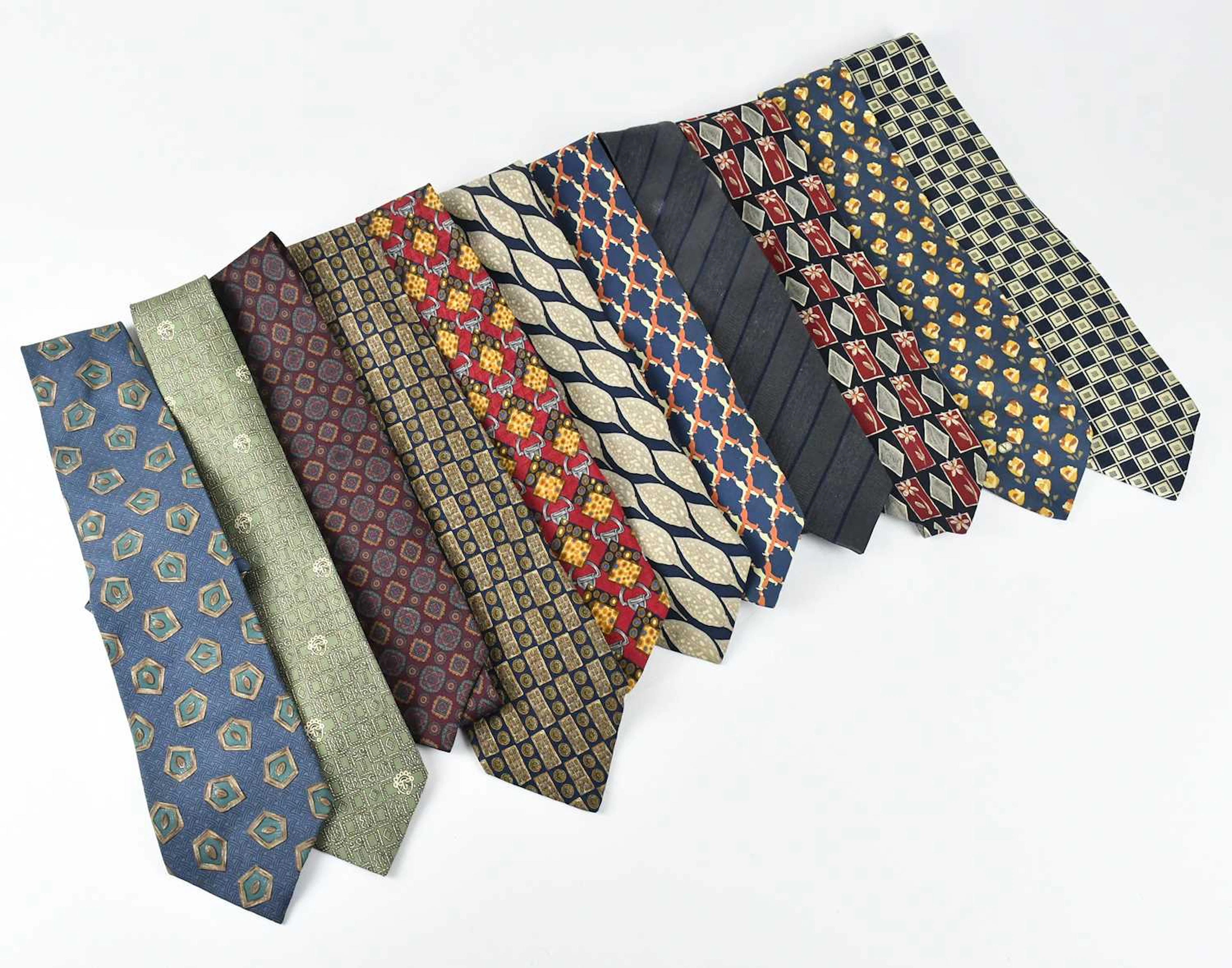 HERMÈS; a khaki green vintage 100% silk tie featuring...