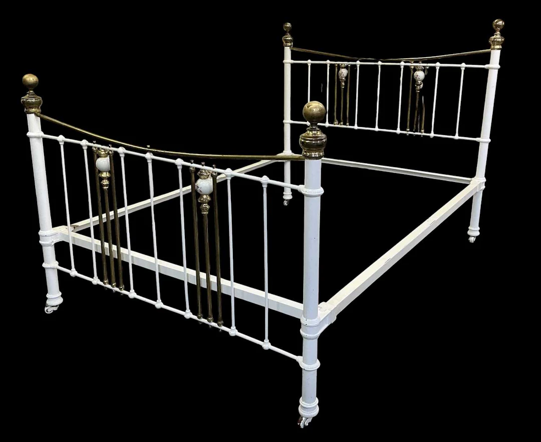 A white painted brass Victorian wrought iron standard double bed