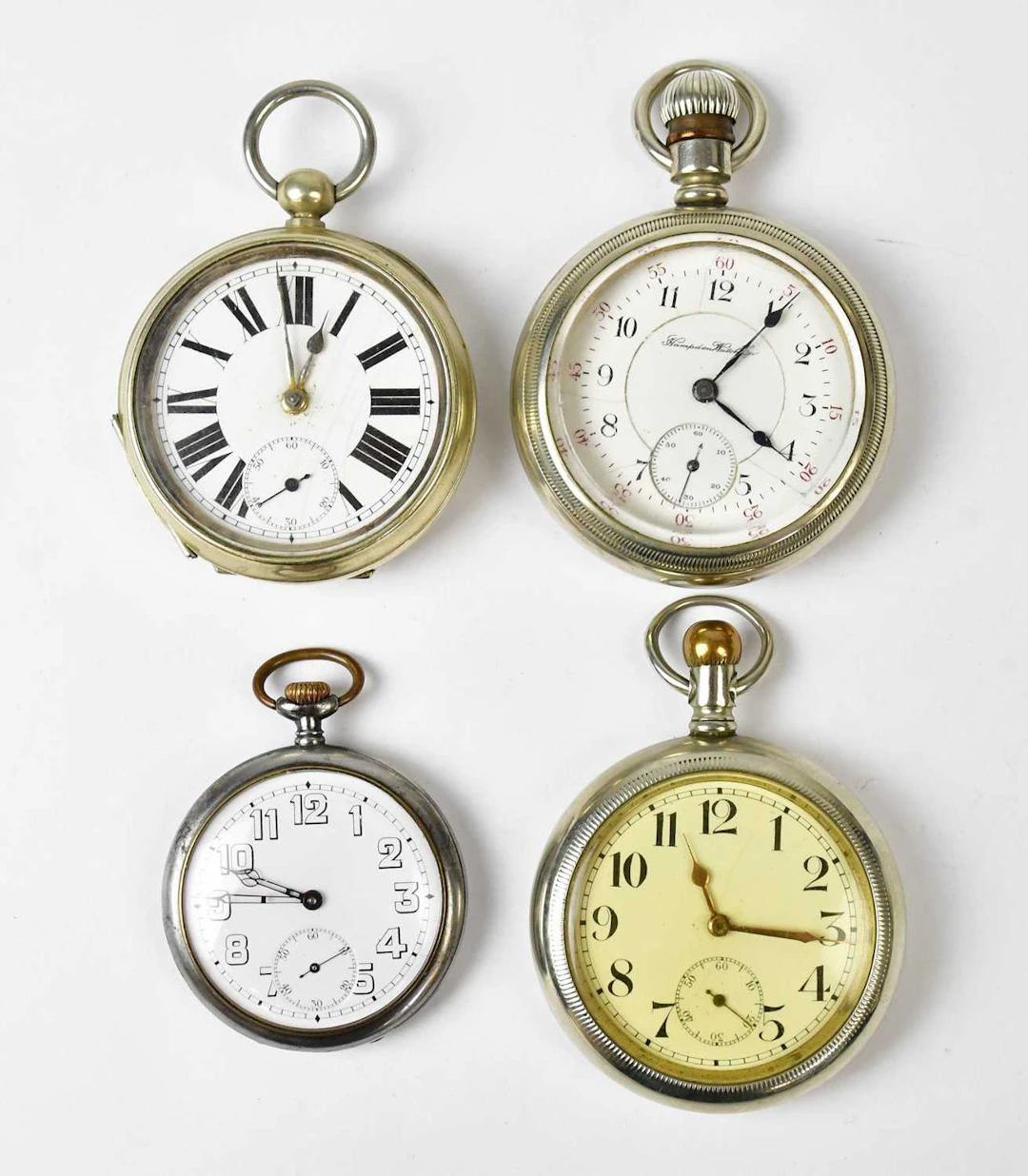 Four silver-plated open face crown and key wind pocket watches