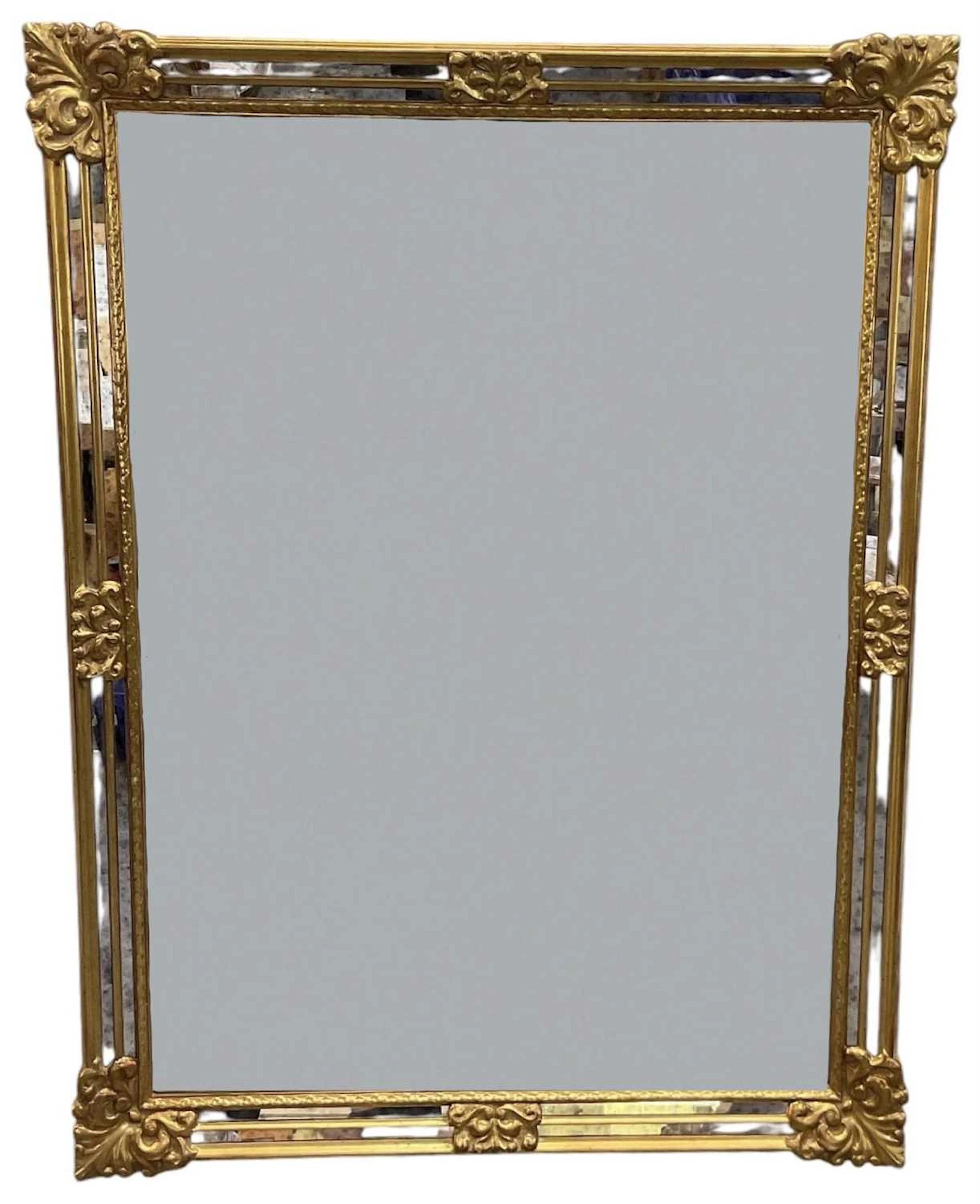 A modern gilt framed bevelled glass rectangular wall mirror