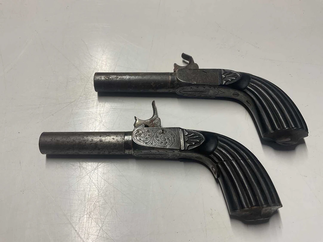 A pair of 19th century percussion cap pistols