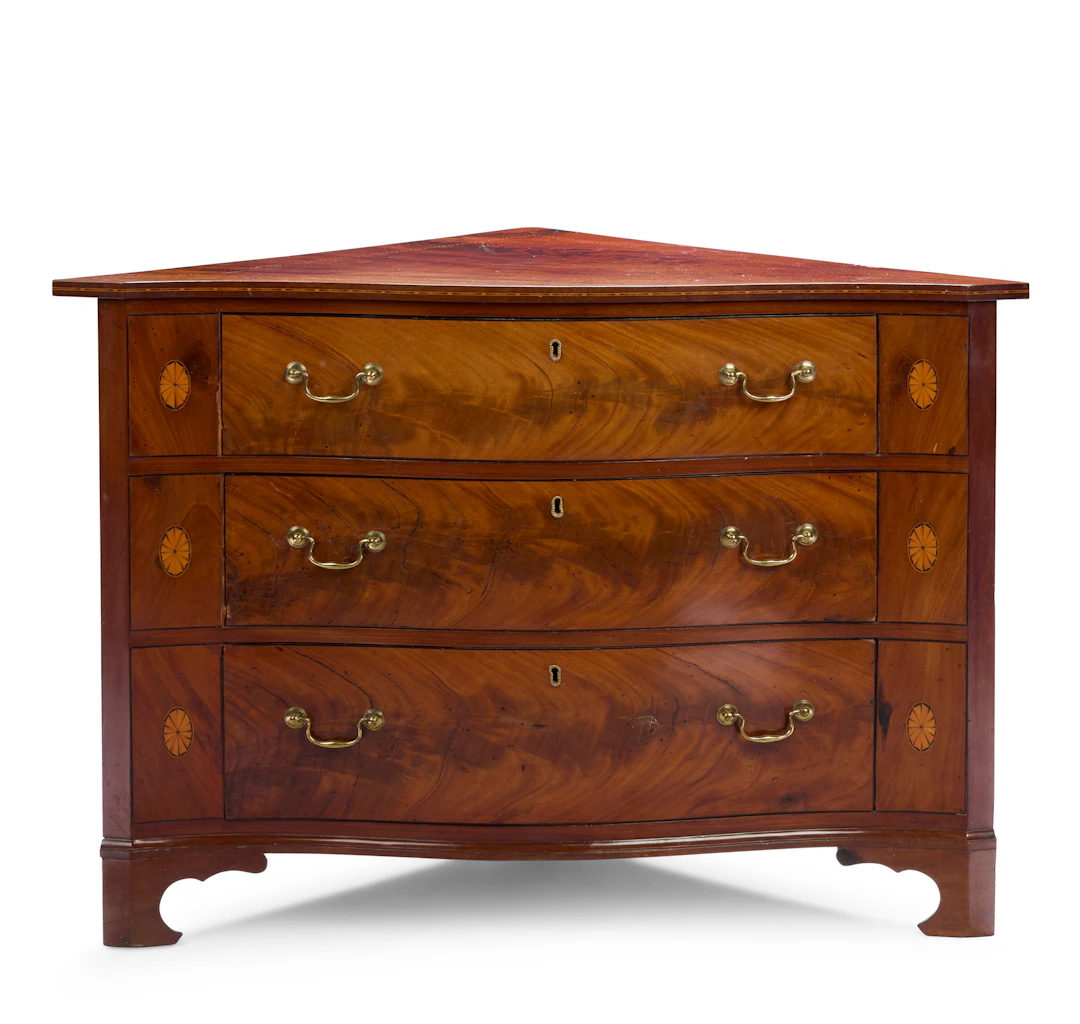GEORGE III MAHOGANY AND INLAID SERPENTINE CORNER CHEST OF DRAWERS