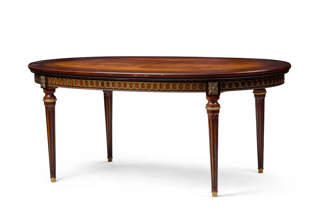 LOUIS XVI STYLE MAHOGANY AND GILT METAL MOUNTED DRAW LEAF DINING TABLE