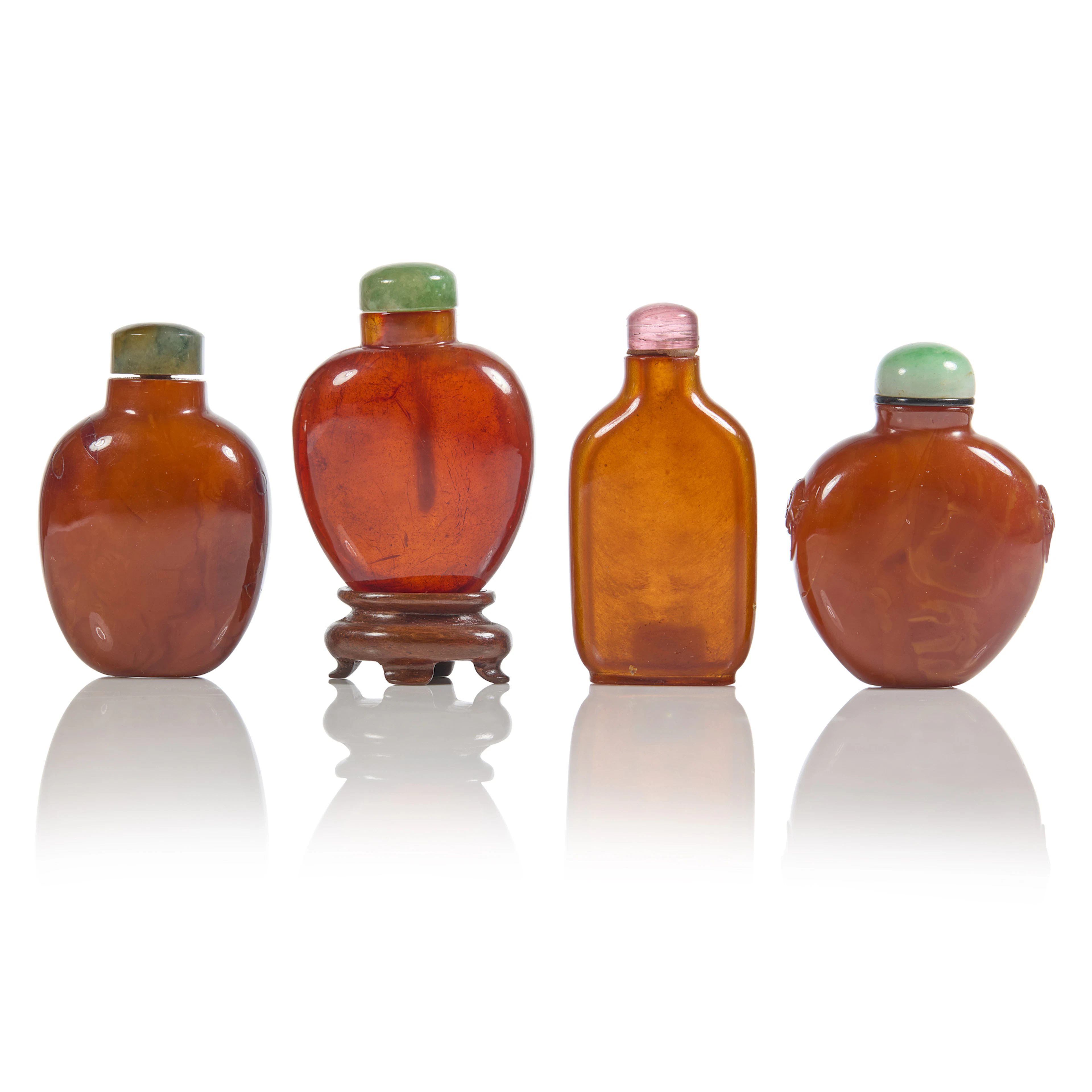 [PRIVATE ENGLISH COLLECTION] GROUP OF FOUR CHINESE AMBER SNUFF BOTTLES