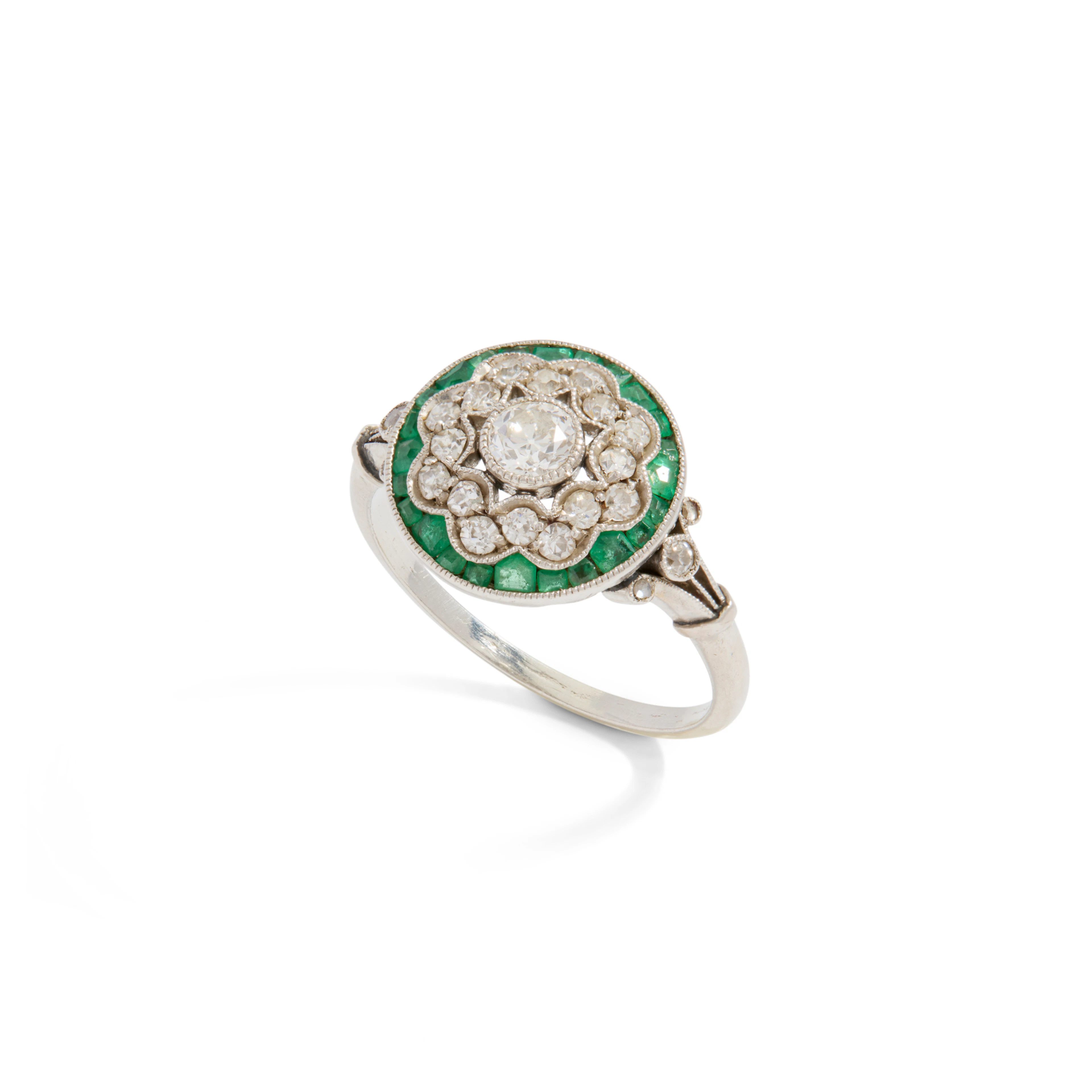 An early 20th century diamond and emerald ring