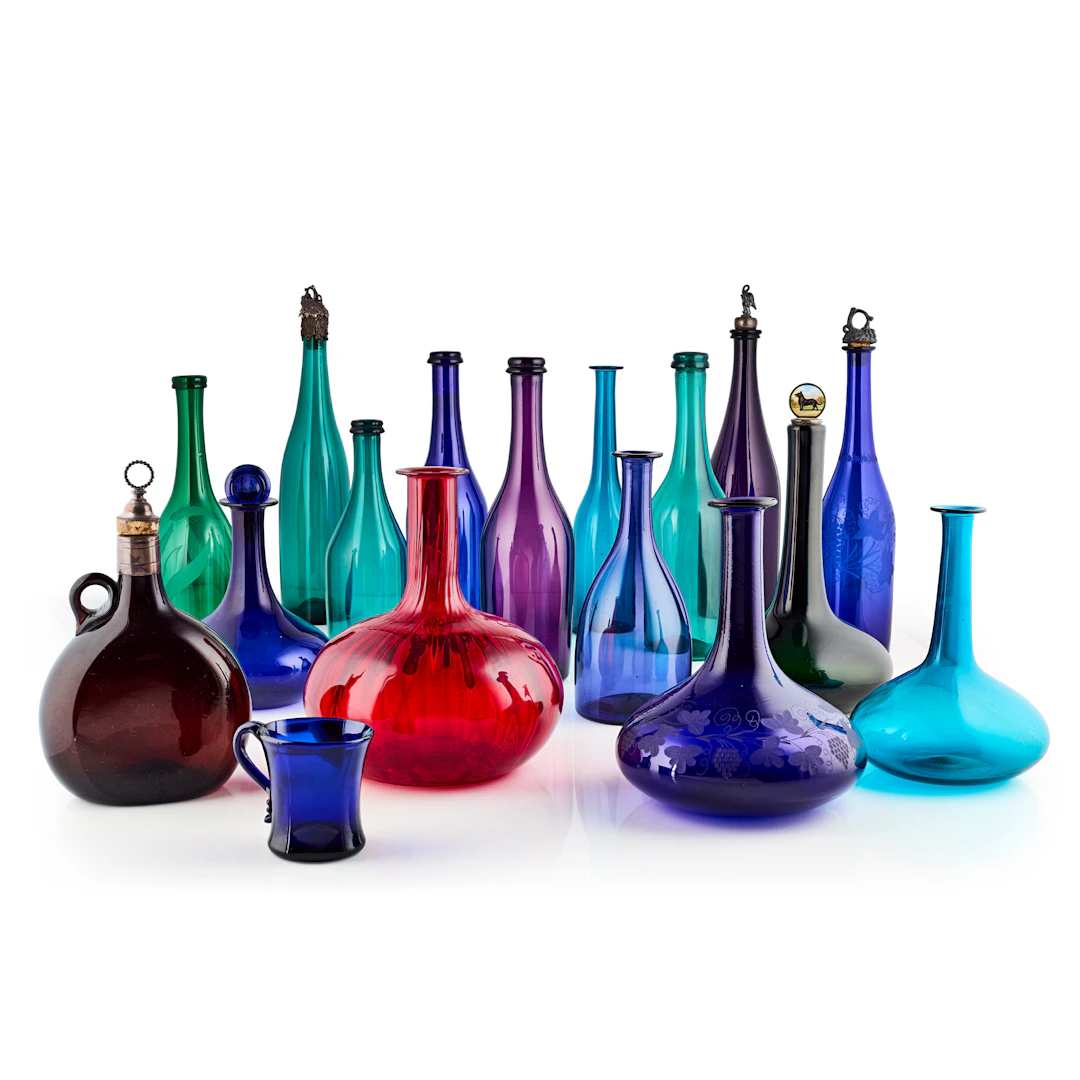 COLLECTION OF COLOURED GLASS BOTTLES AND DECANTERS