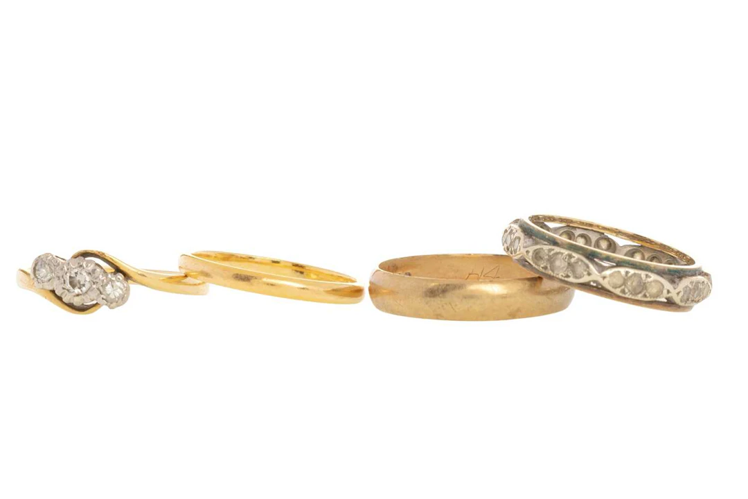 DIAMOND THREE STONE RING AND THREE FURTHER RINGS