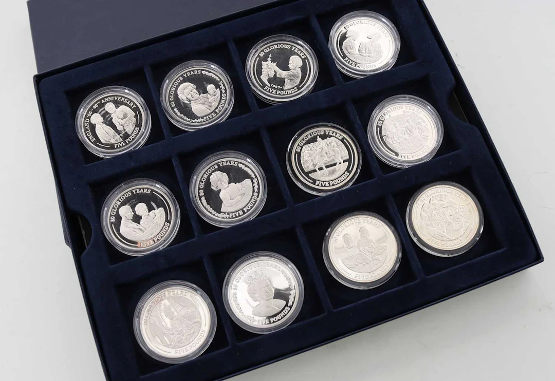 COLLECTION OF TWELVE SILVER COMMEMORATIVE COINS 80 GLORIOUS YEARS 2006