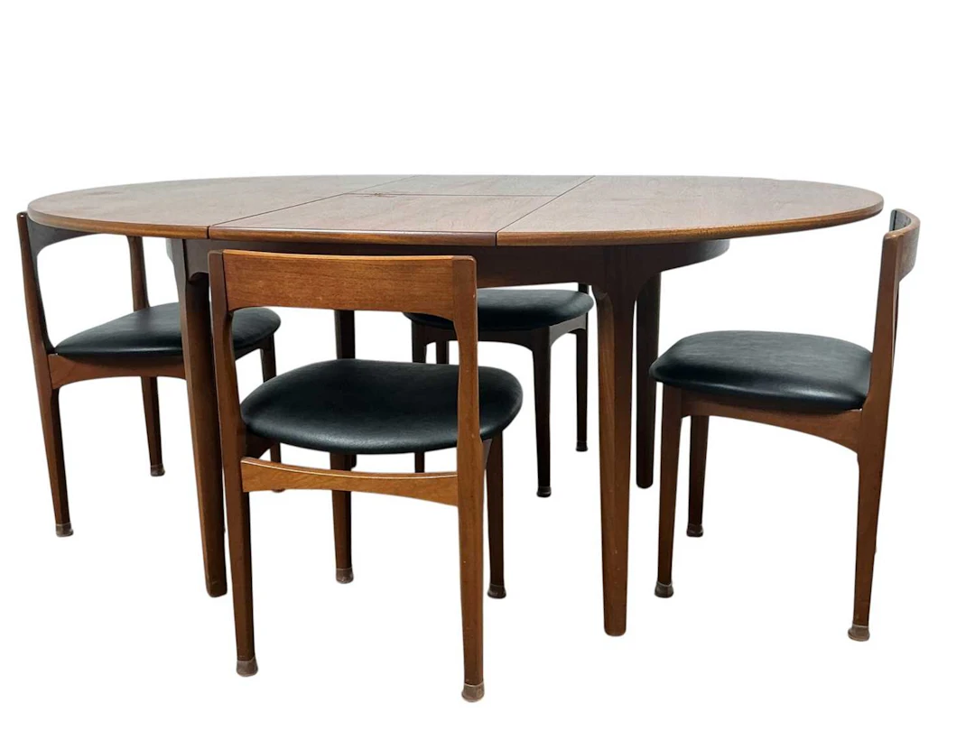 NATHAN TEAK CIRCULAR EXTENDING DINING TABLE AND FOUR CHAIRS MID 20TH CENTURY