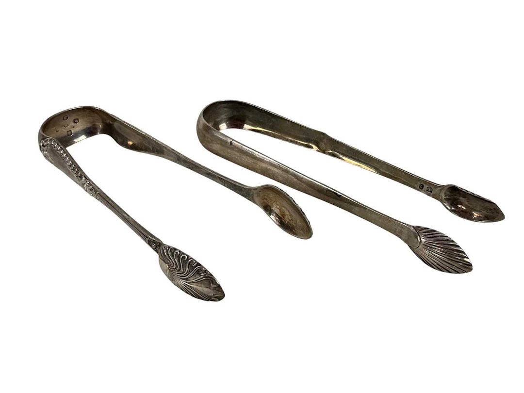 TWO PAIRS OF SILVER SUGAR TONGS ALONG WITH A SILVER NAPKIN RING AND SPOONS