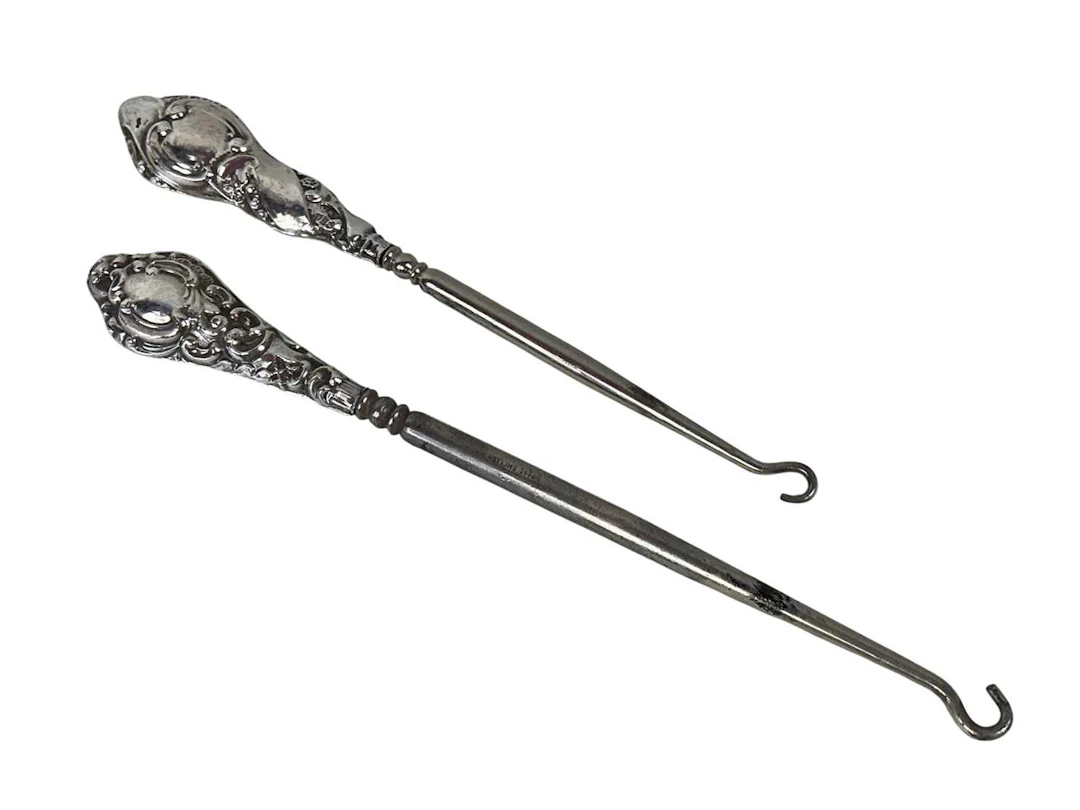 TWO BUTTON HOOKS WITH SILVER MOUNTED HANDLES, EARLY 20TH CENTURY AND